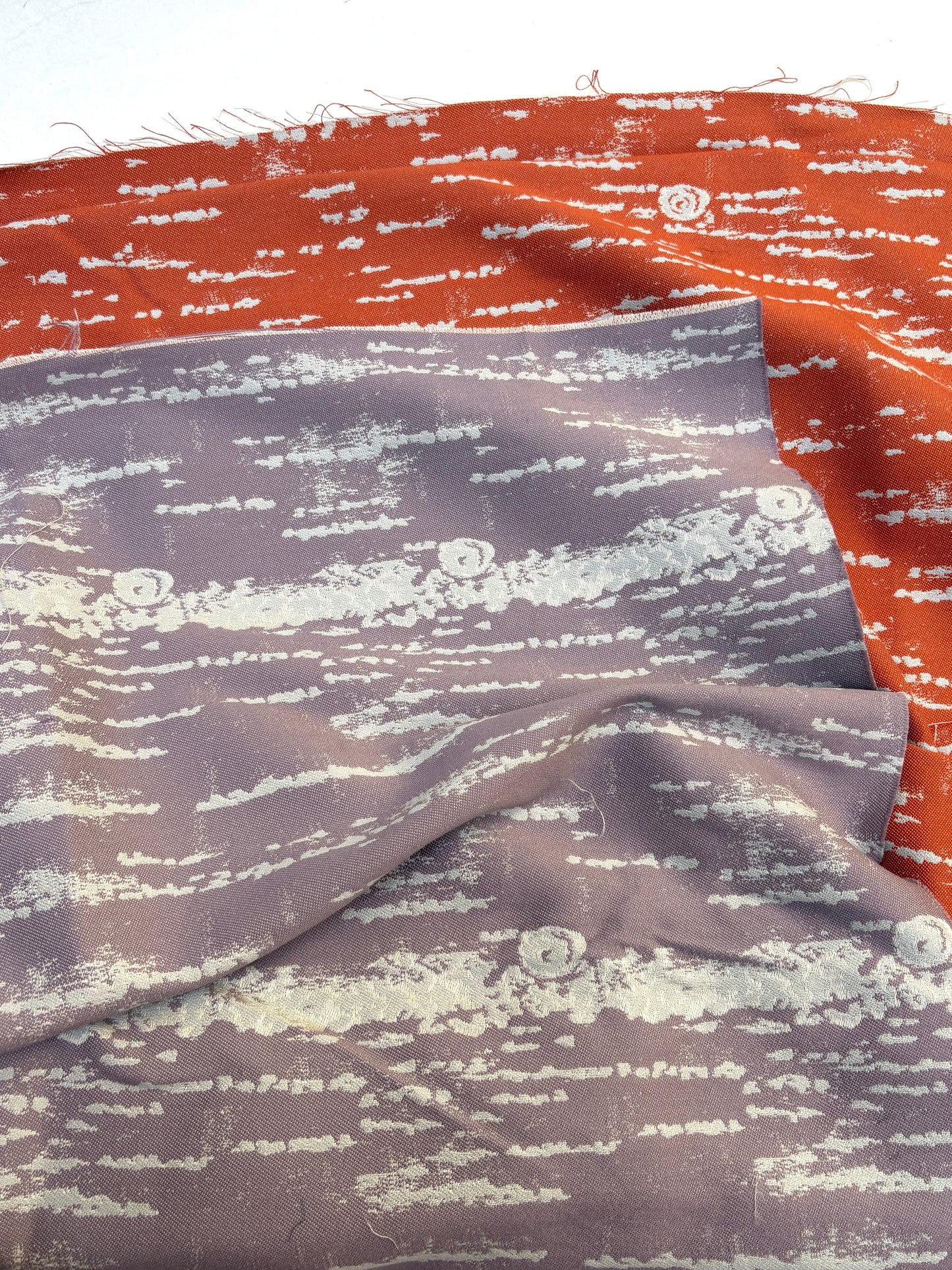 Close-up of red and purple silk a white background