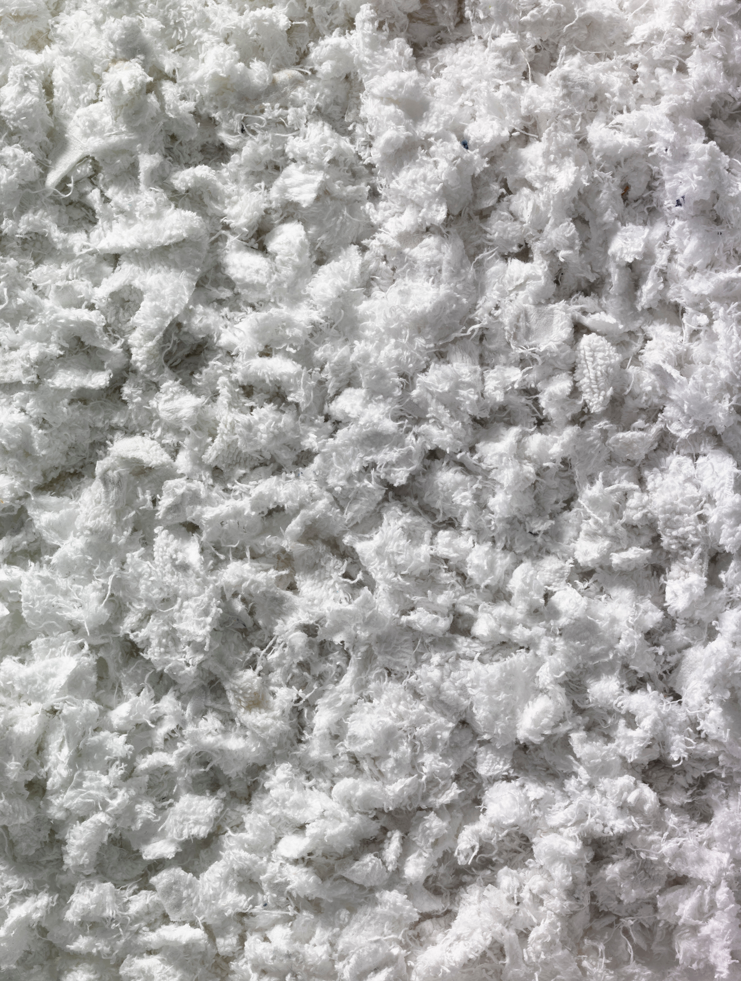 A close-up view of a collection of shredded white textiles.