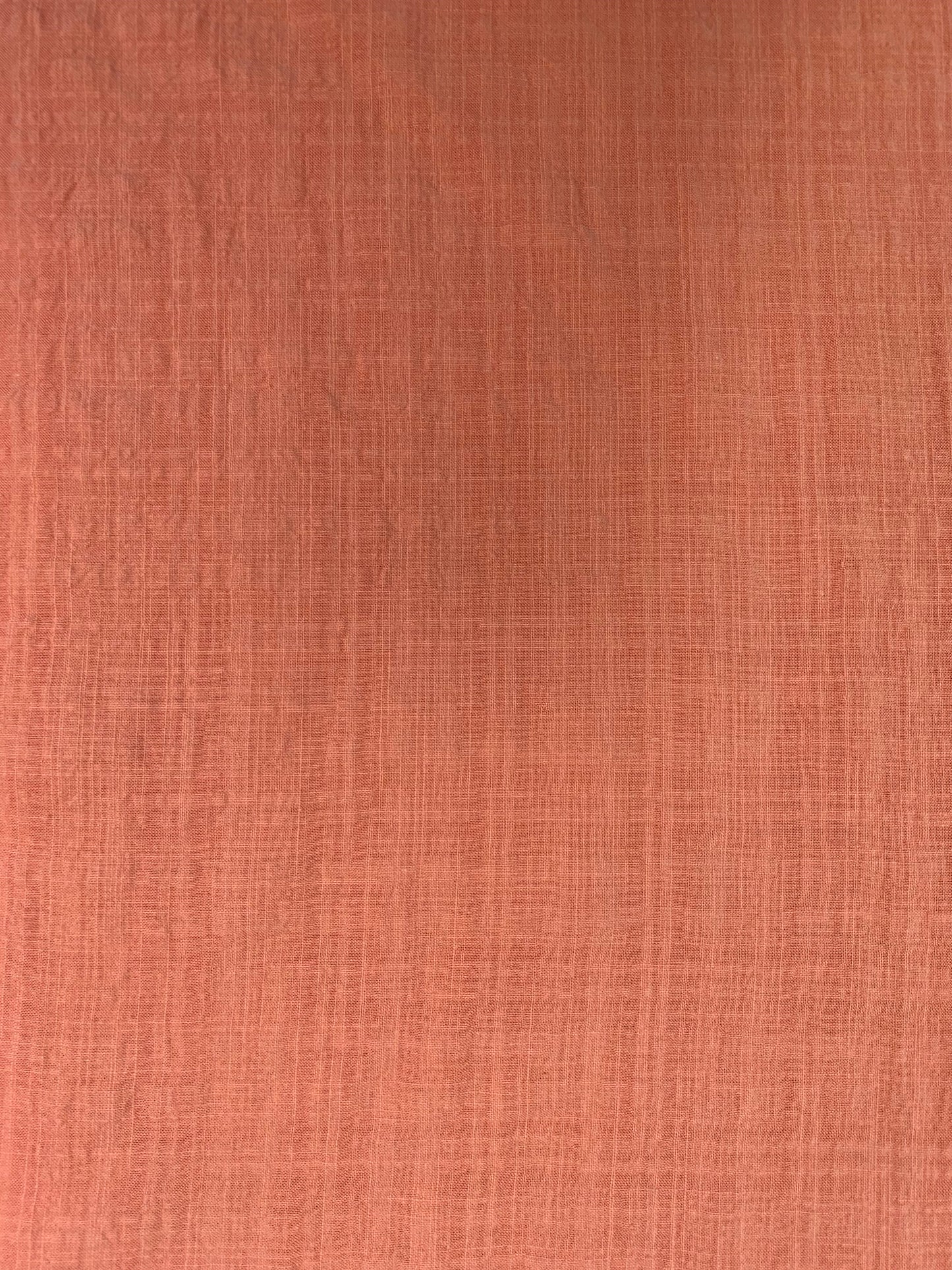 A detailed fabric shot highlighting the peach check and subtle texture.