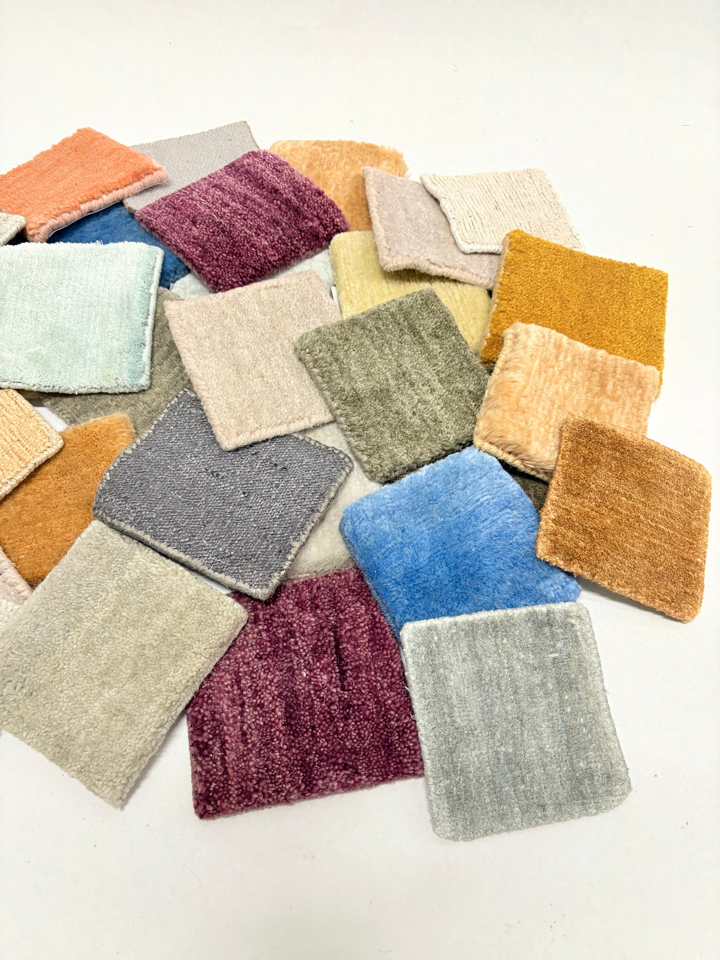 Velvet fabric swatches in assorted colours arranged on a white background.