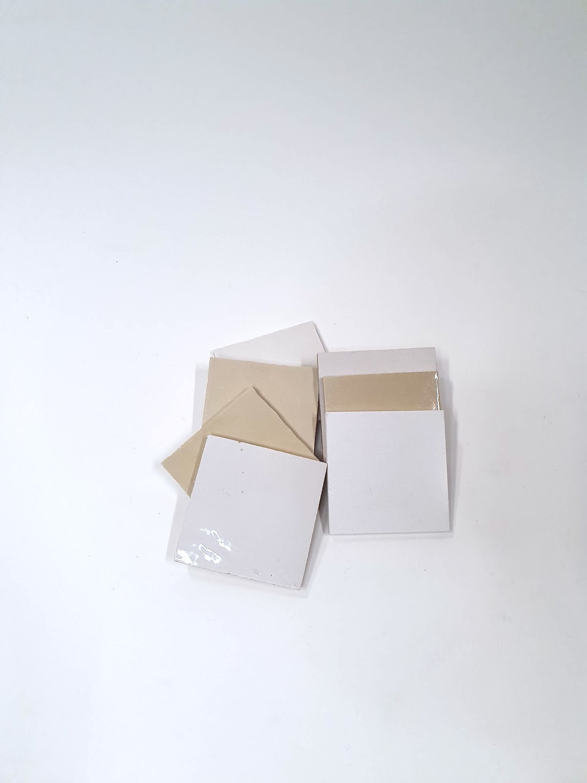 Small white sample boards are displayed in a simple stacked arrangement.