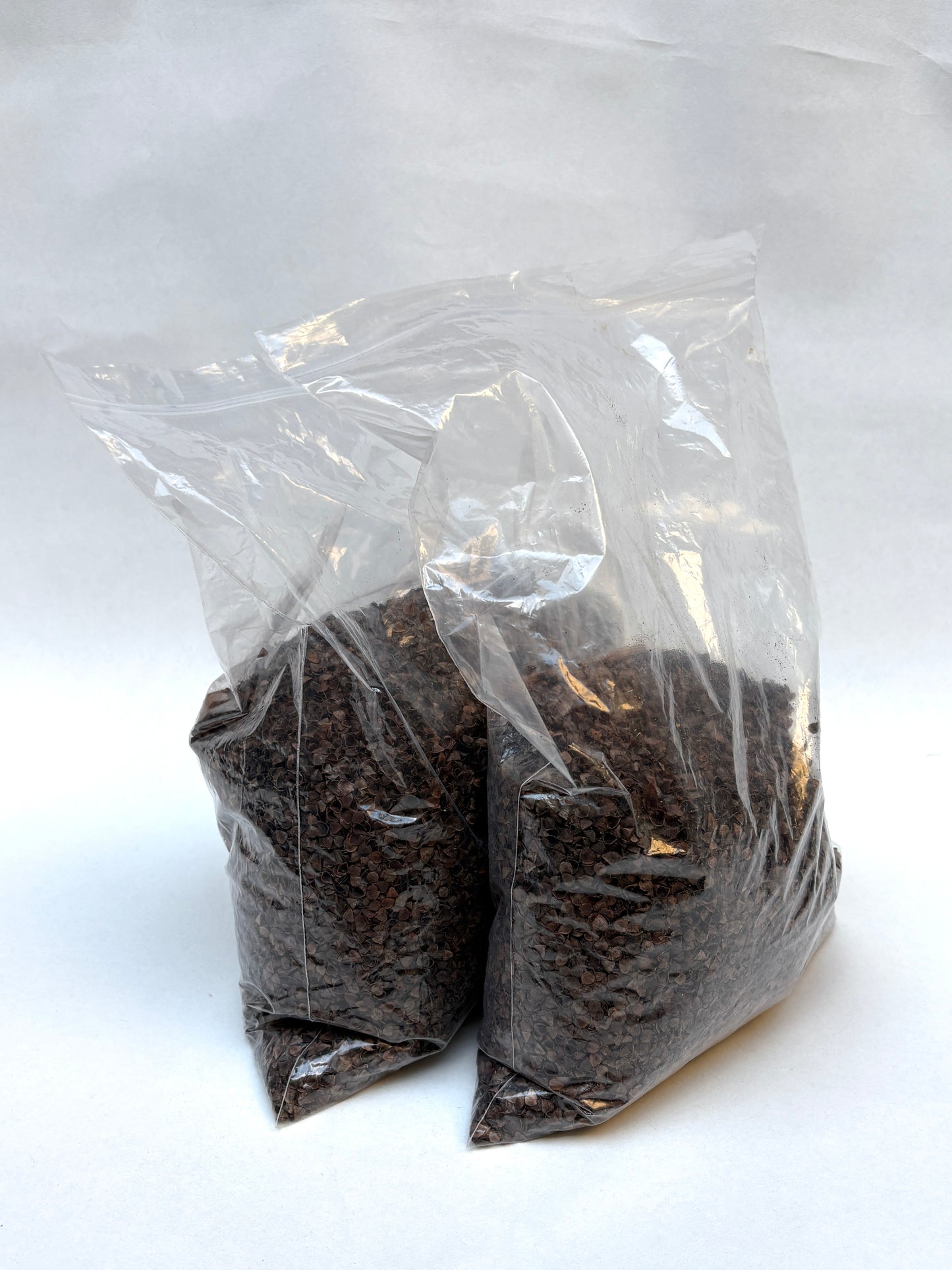 Fluffy pale fibre sits inside a clear plastic bag