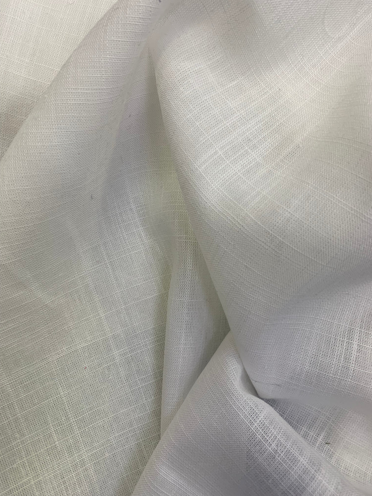 White viscose linen deadstock fabric shown in a softly folded close-up.
