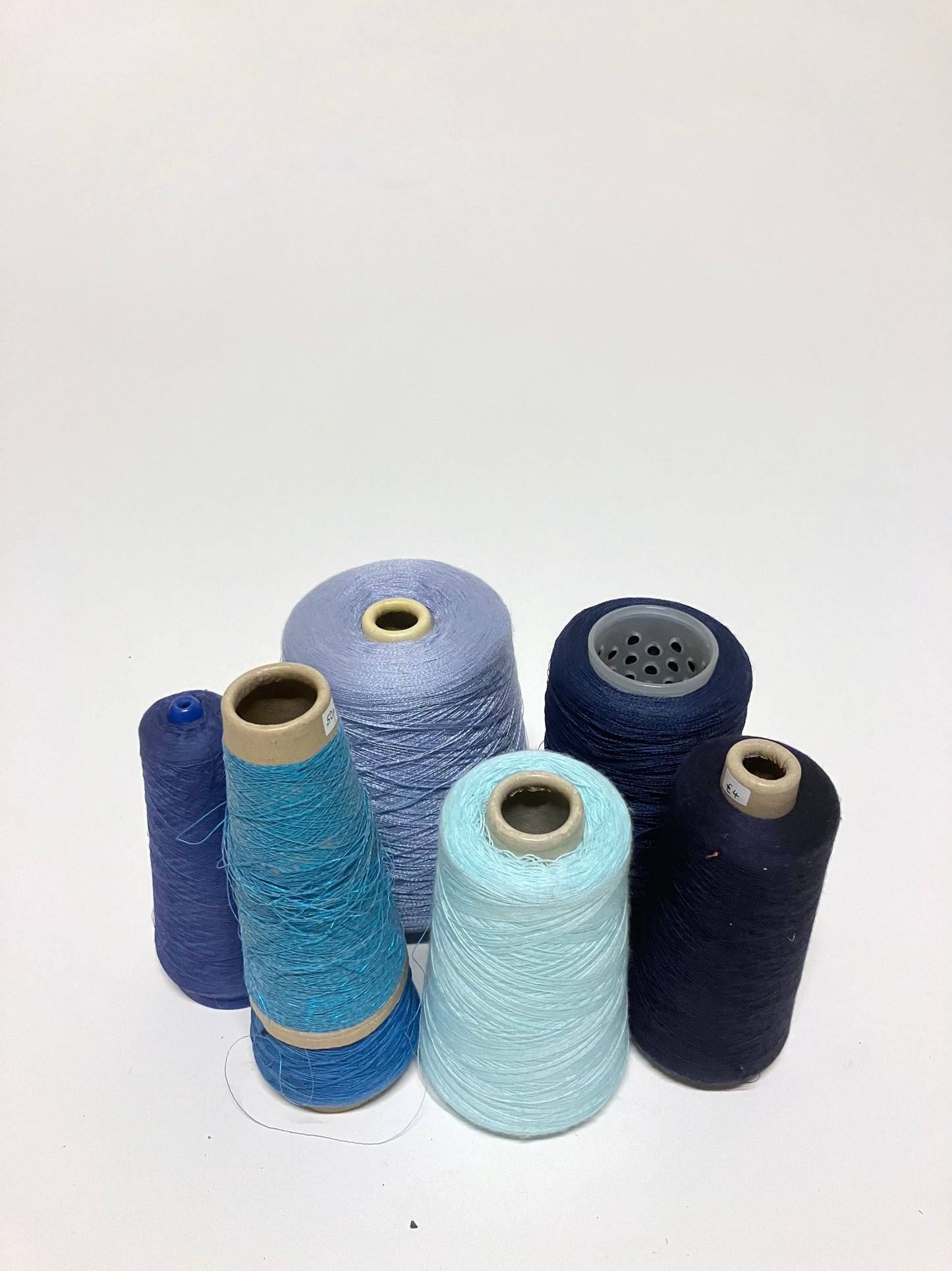 Mixed blue thread cones are shown from front and side angles