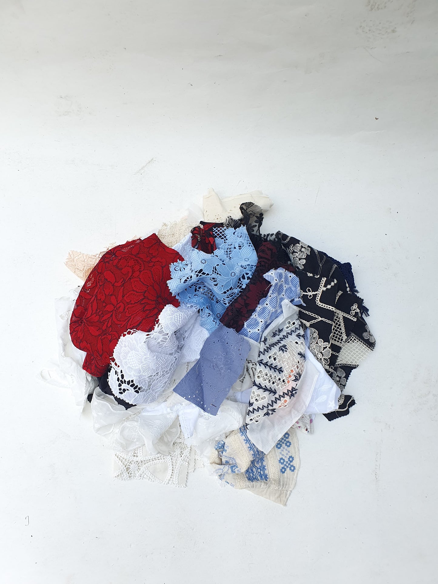 Collection of decorative lace fabric offcuts in various colours
