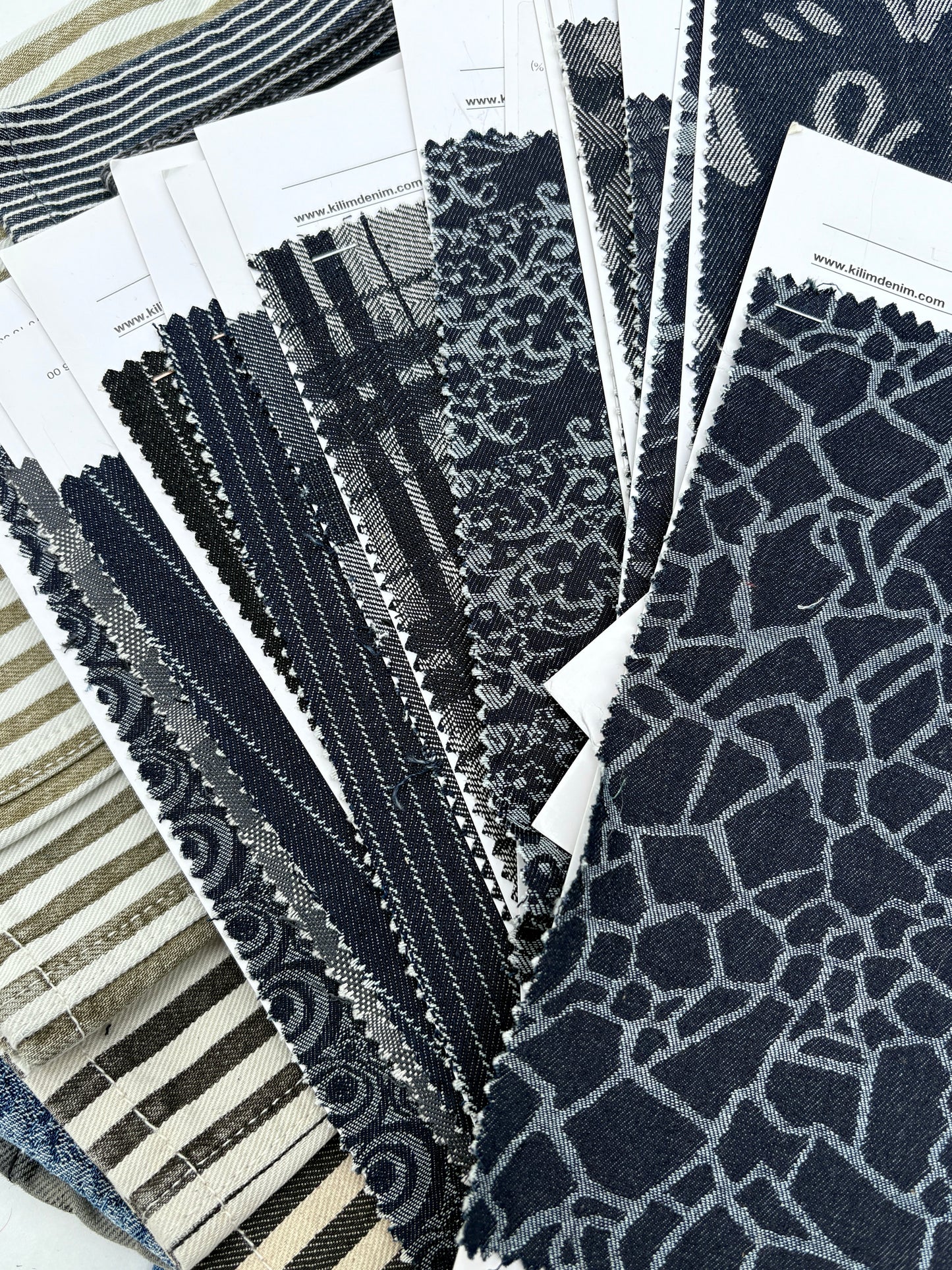 Collection of denim fabric swatches with various patterns