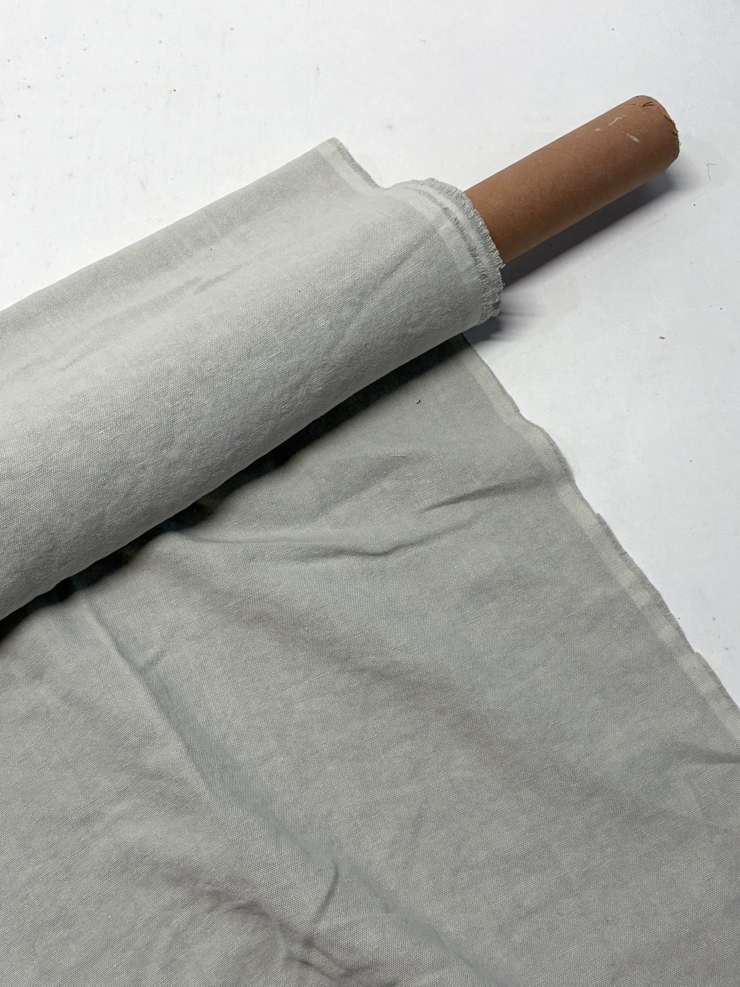 Roll of medium weight linen fabric in grey