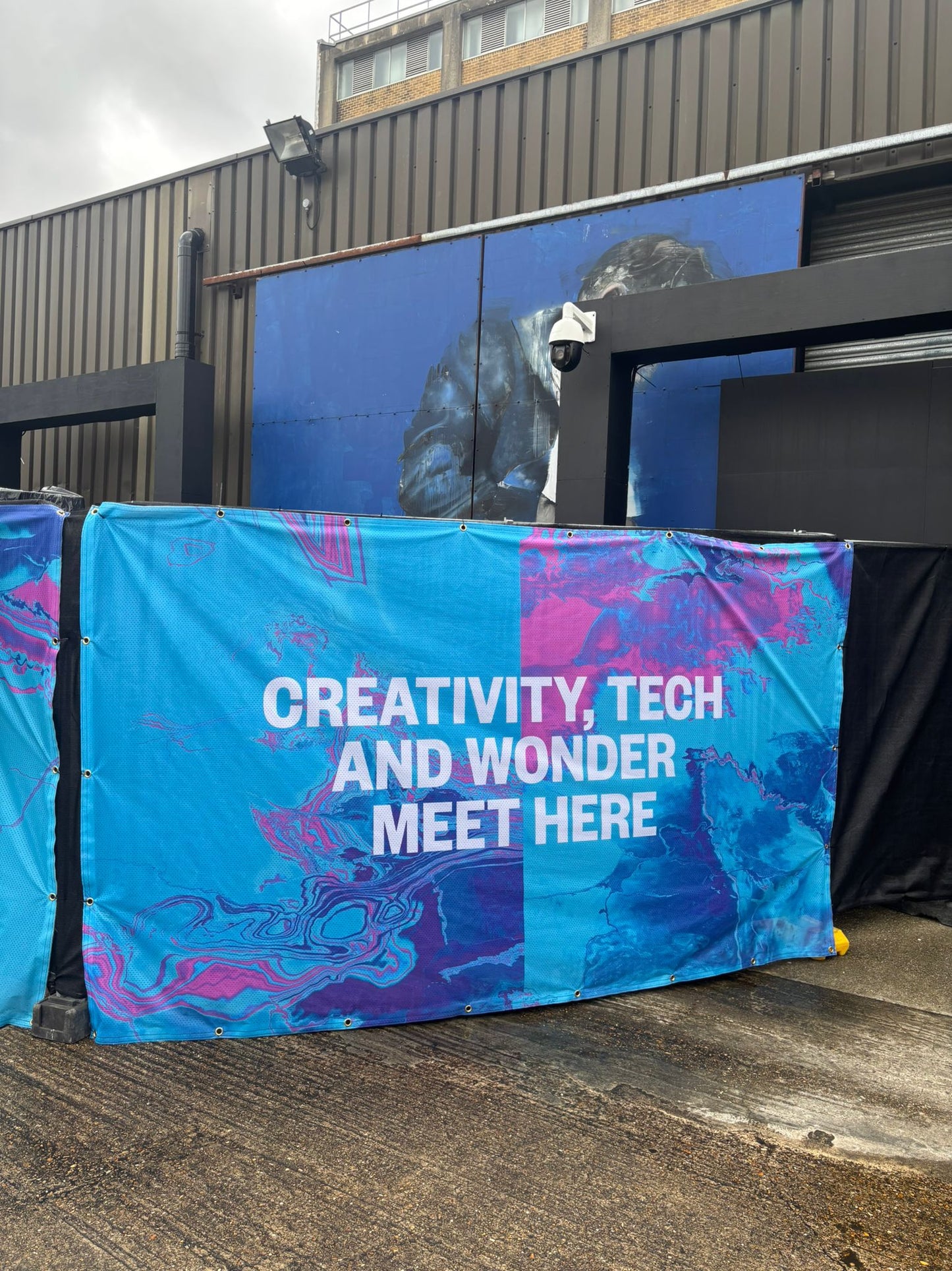 Fabric banner reading 'Creativity, Tech and Wonder Meet Here' in blue