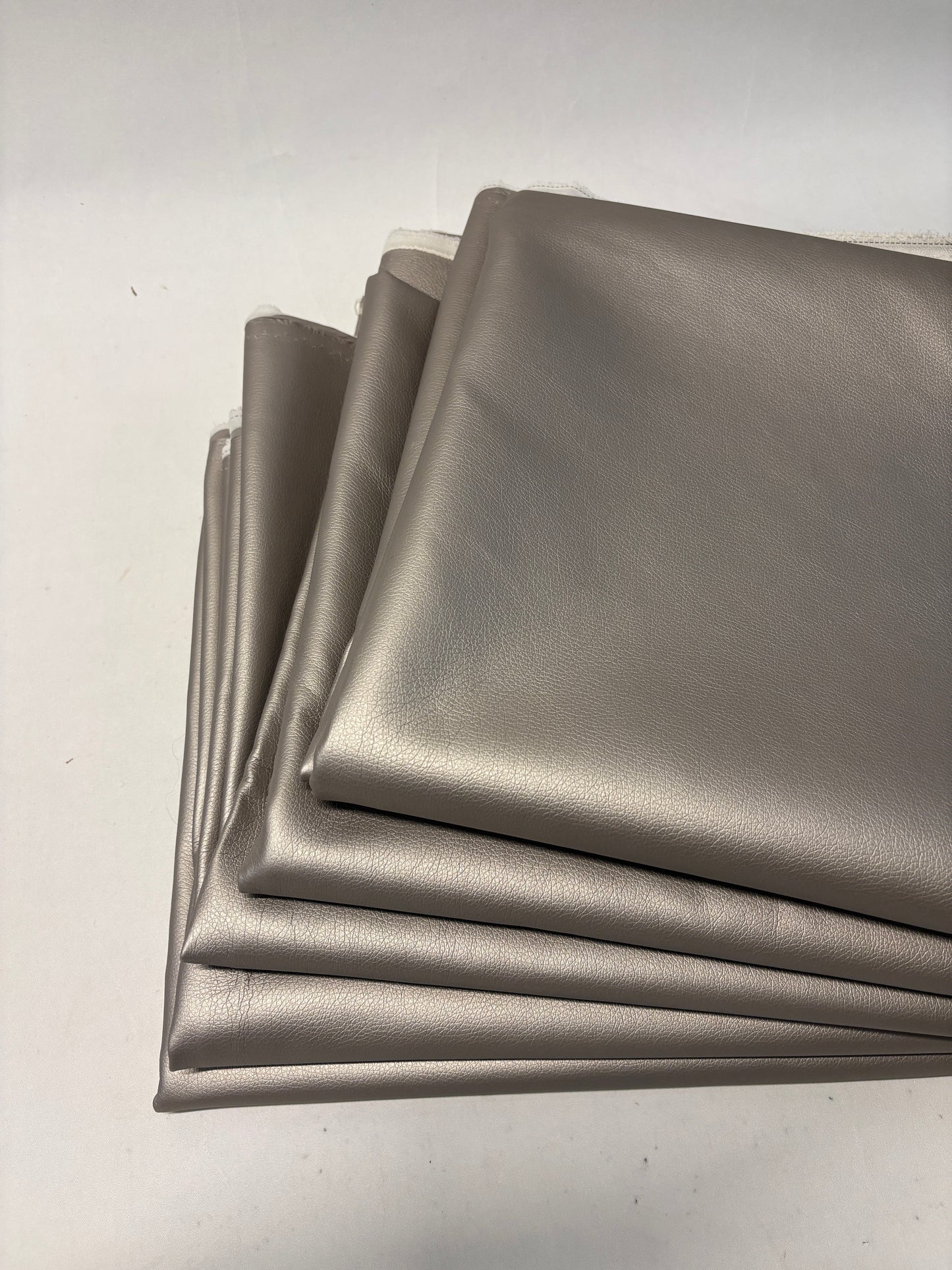 Stack of faux leather in metallic bronze