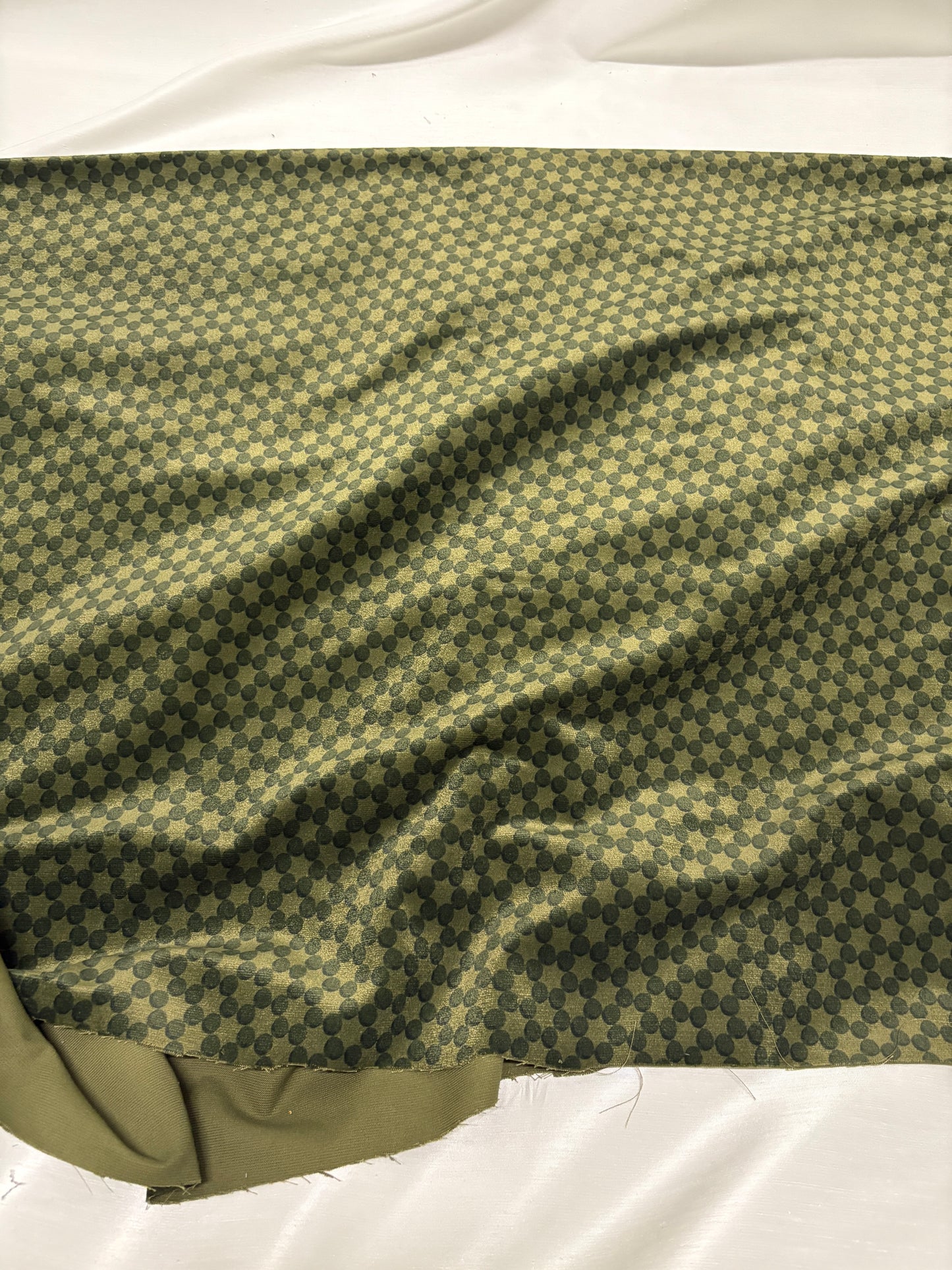 Green dot velvet fabric with shiny texture visible