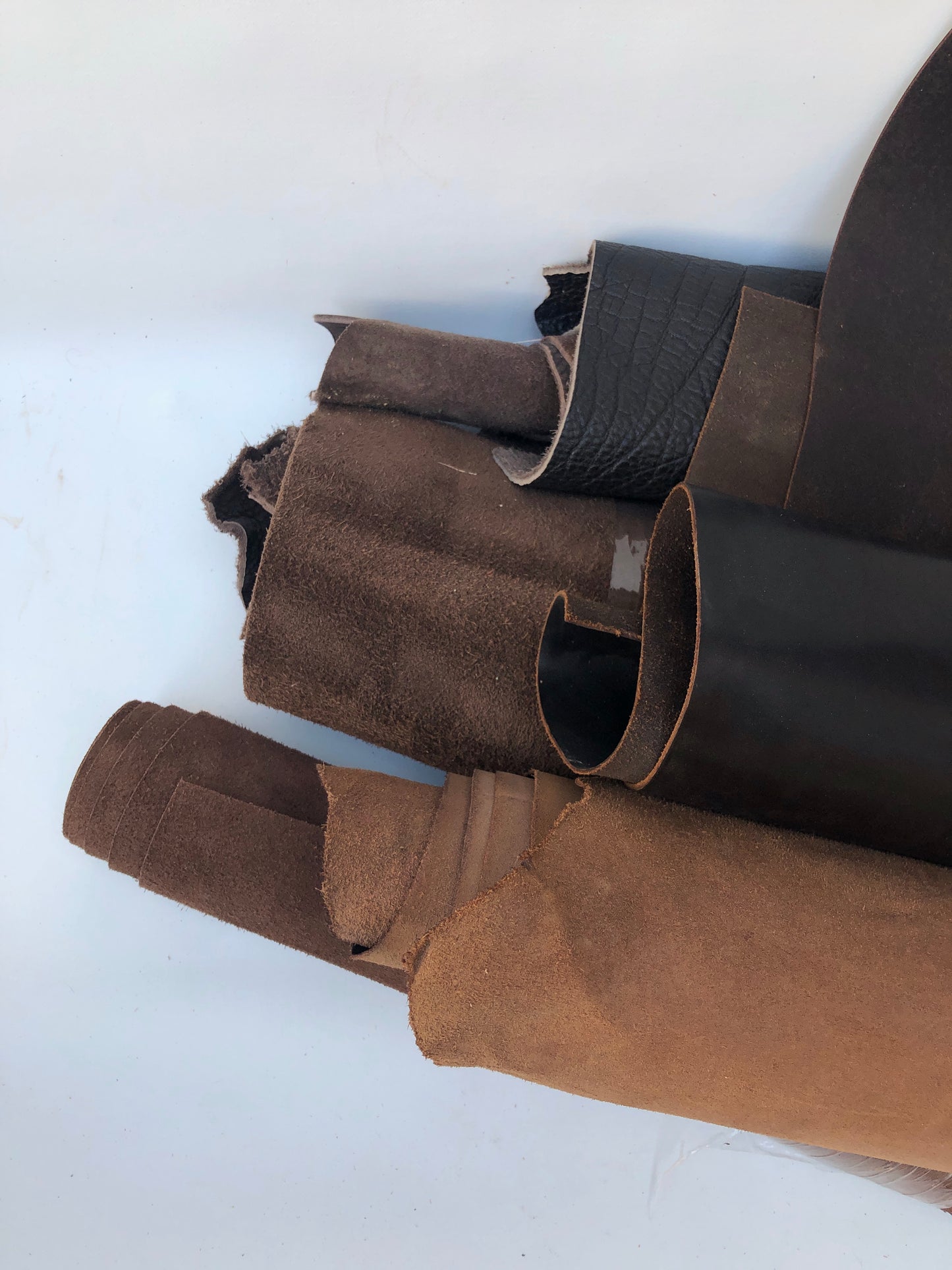 Close-up of a collection of dark brown rolled leather