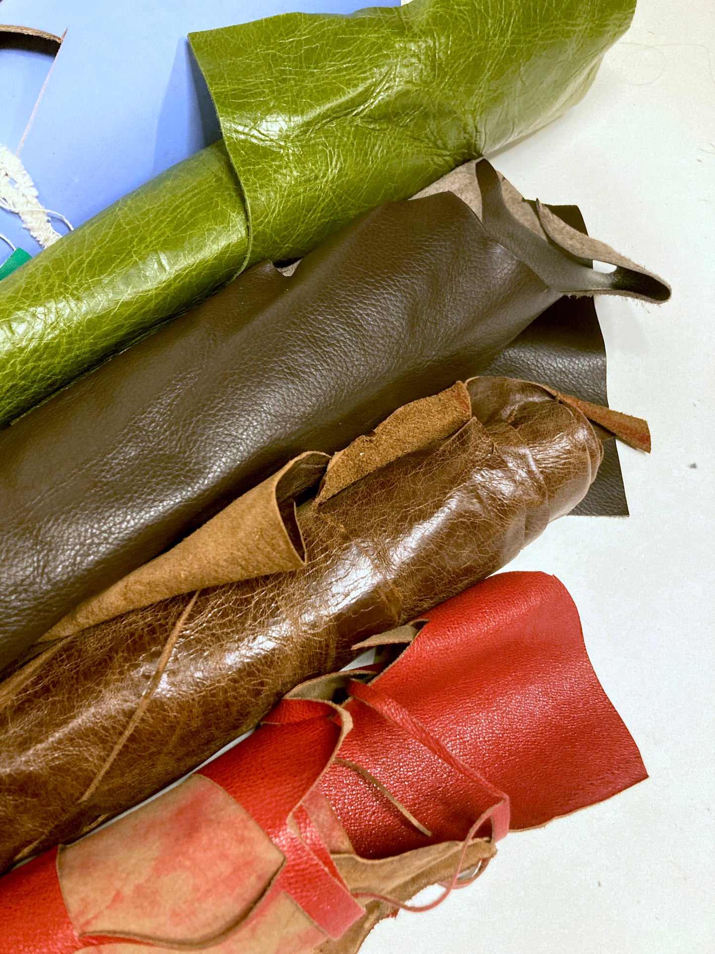 Collection of various coloured leather rolls with shiny texture