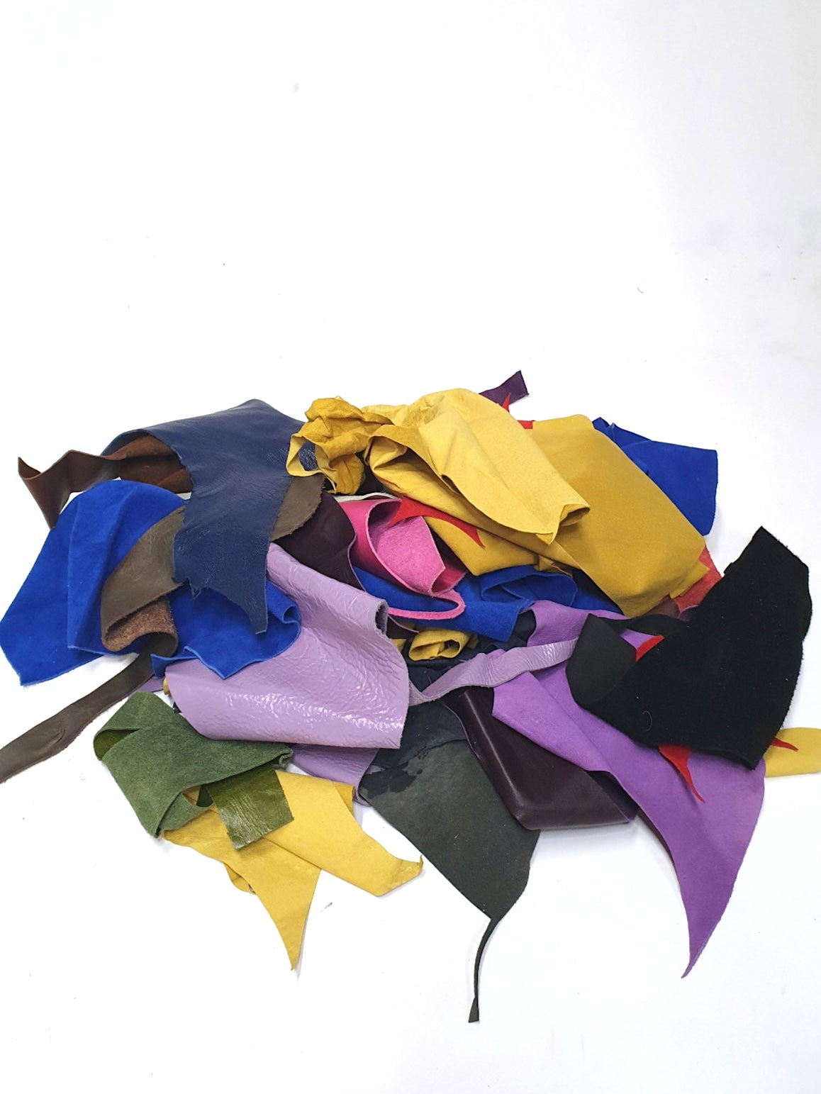 Pile of colourful leather offcuts with various textures