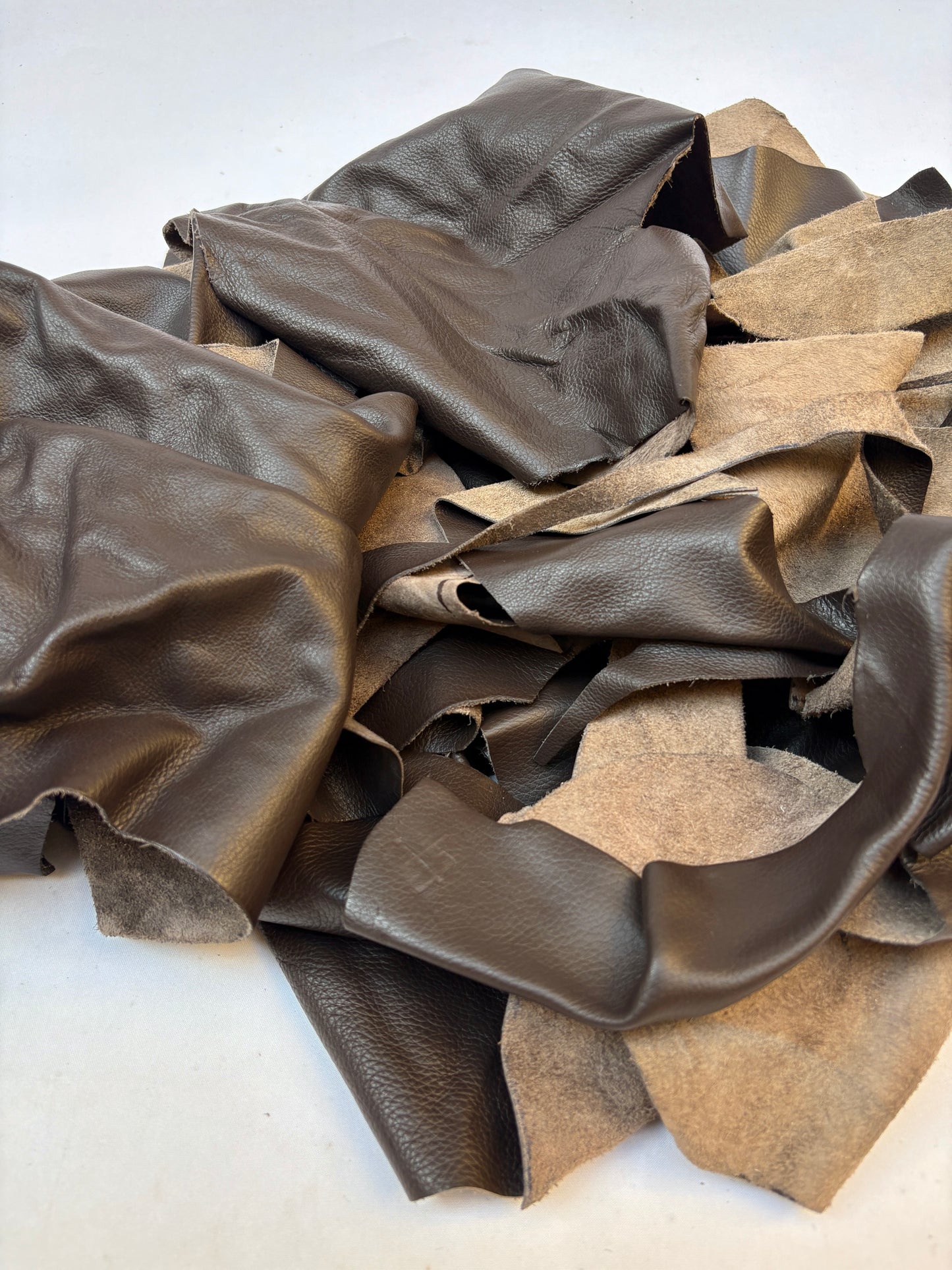 Pile of dark brown leather offcuts