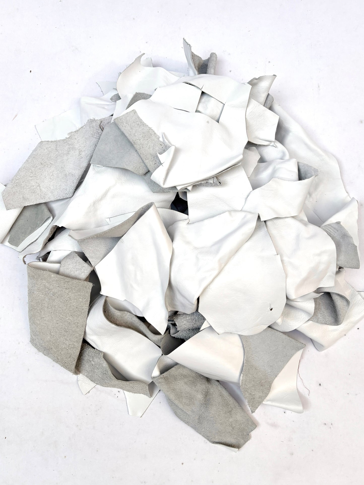 Collection of white off-cut leather pieces