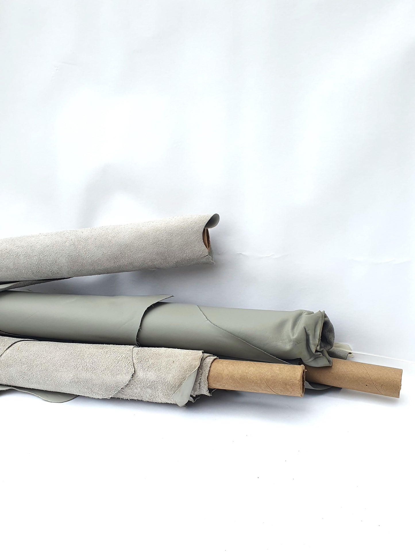 Collection of rolled up grey and light grey leather