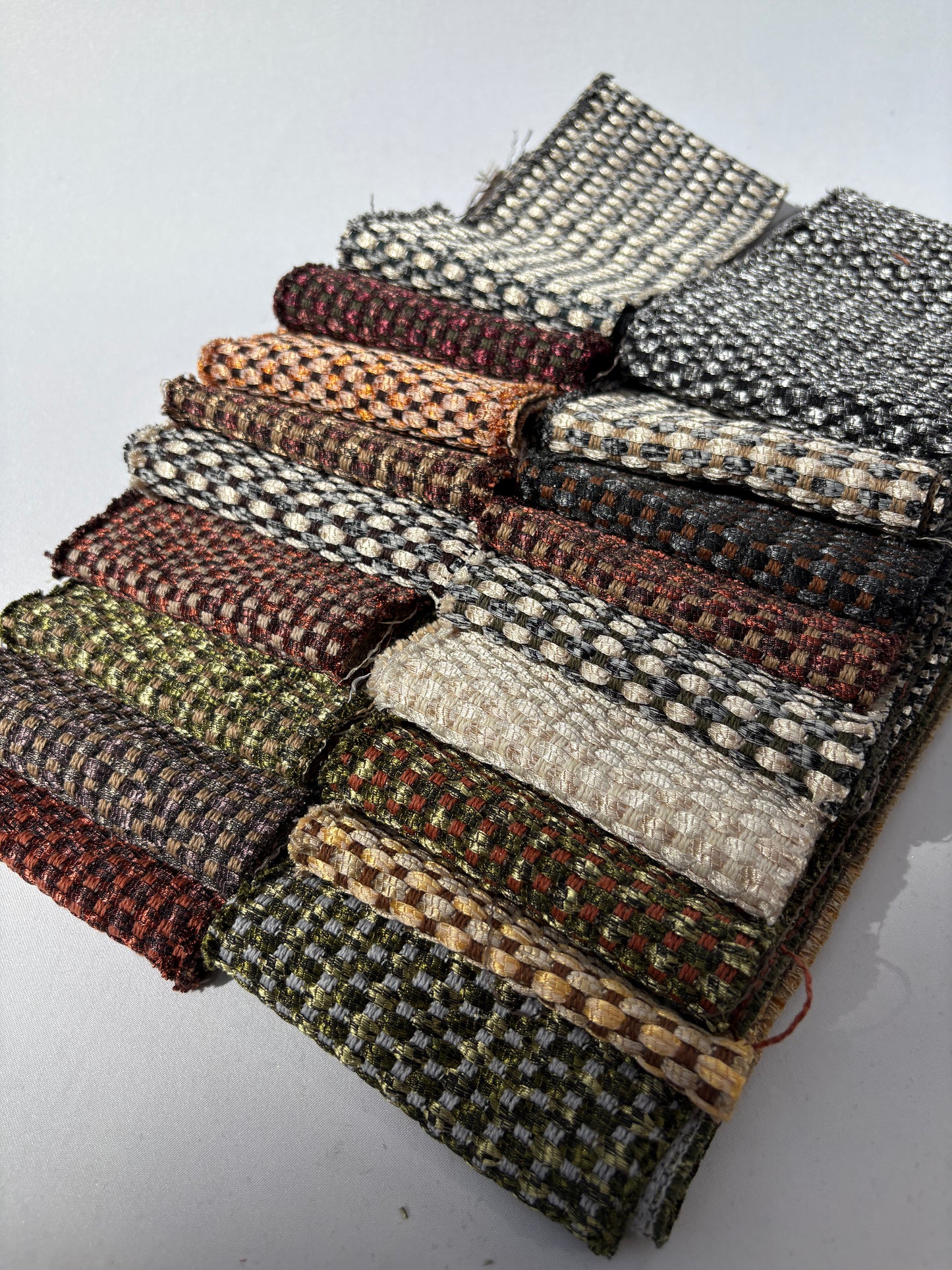 Long fabric offcuts in mixed shimmer patterns displayed on a white background.