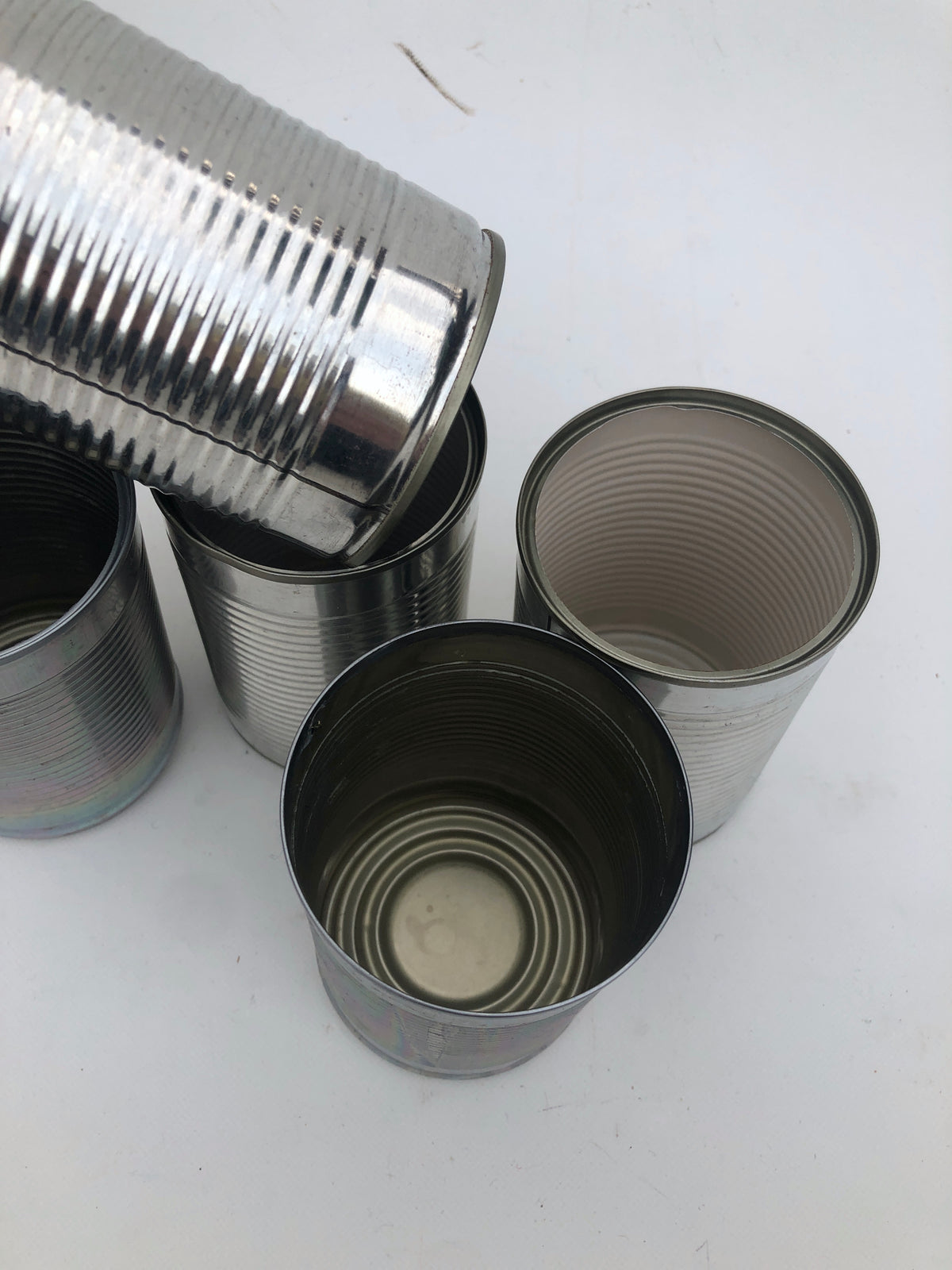 five empty metal cans