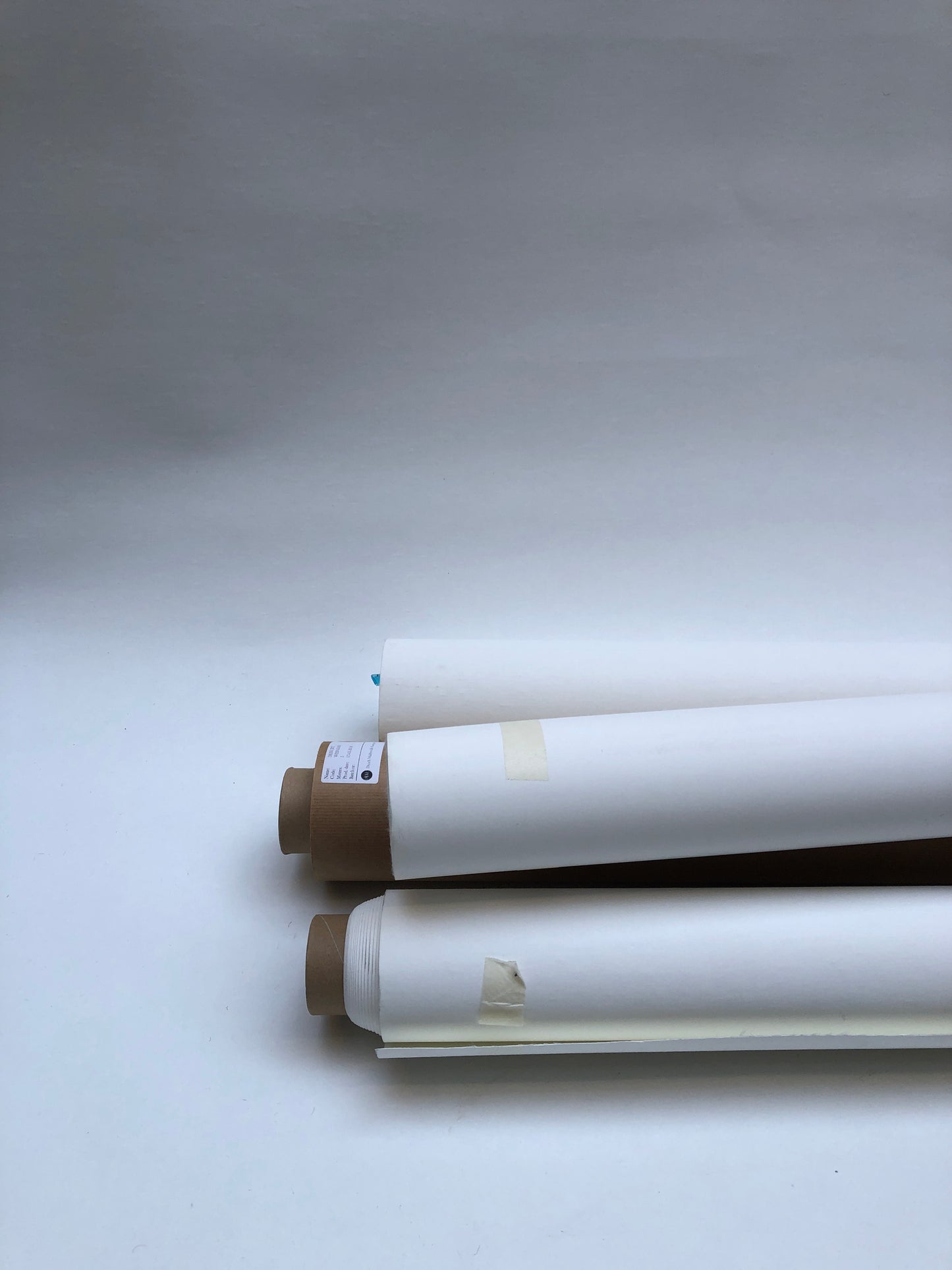 Collection of rolled white canvas papers