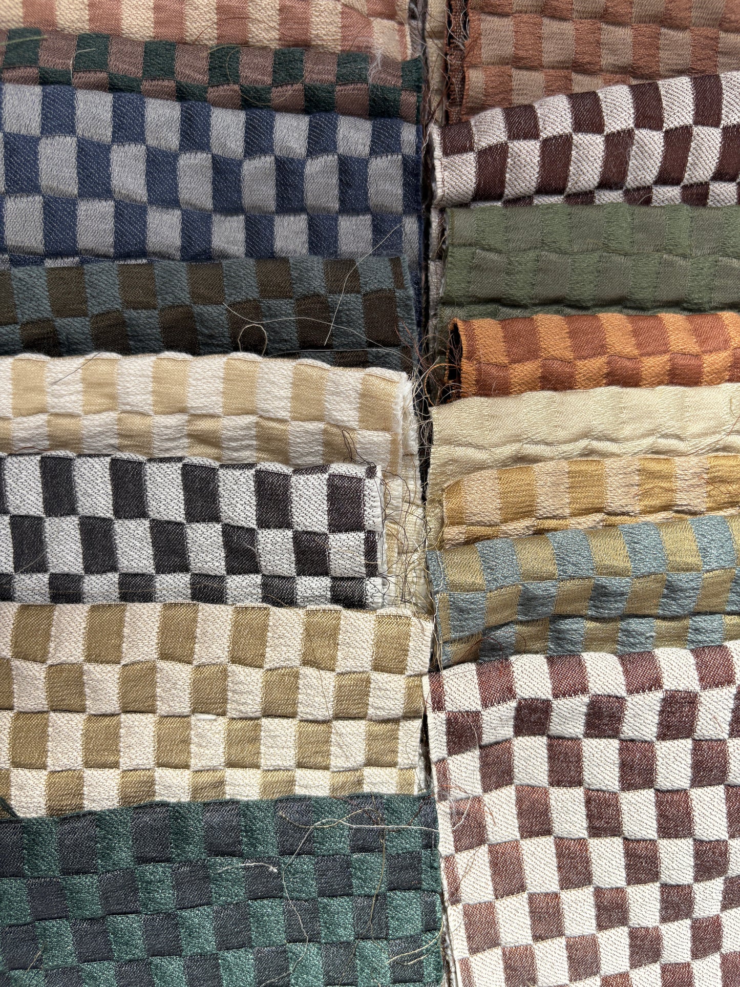 Collection of checkered quilted fabric offcuts in various colours.