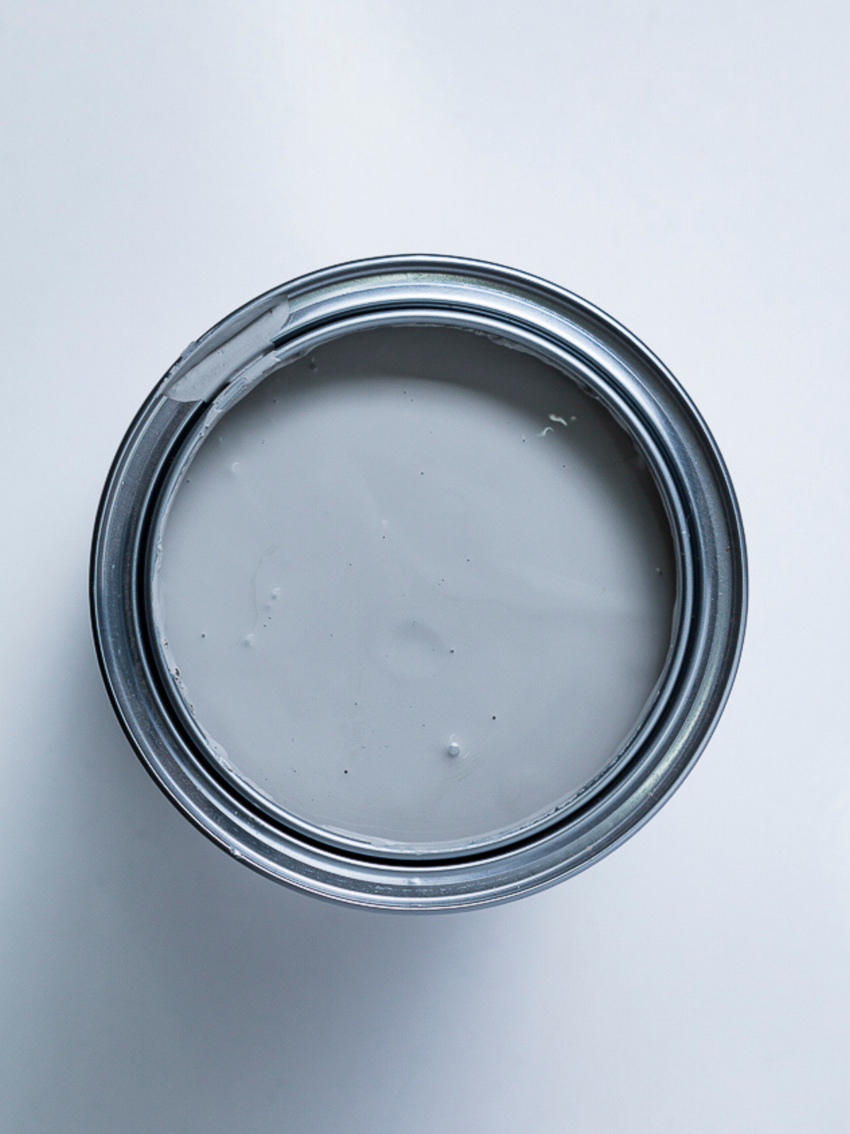 Top view of an open can of grey paint.