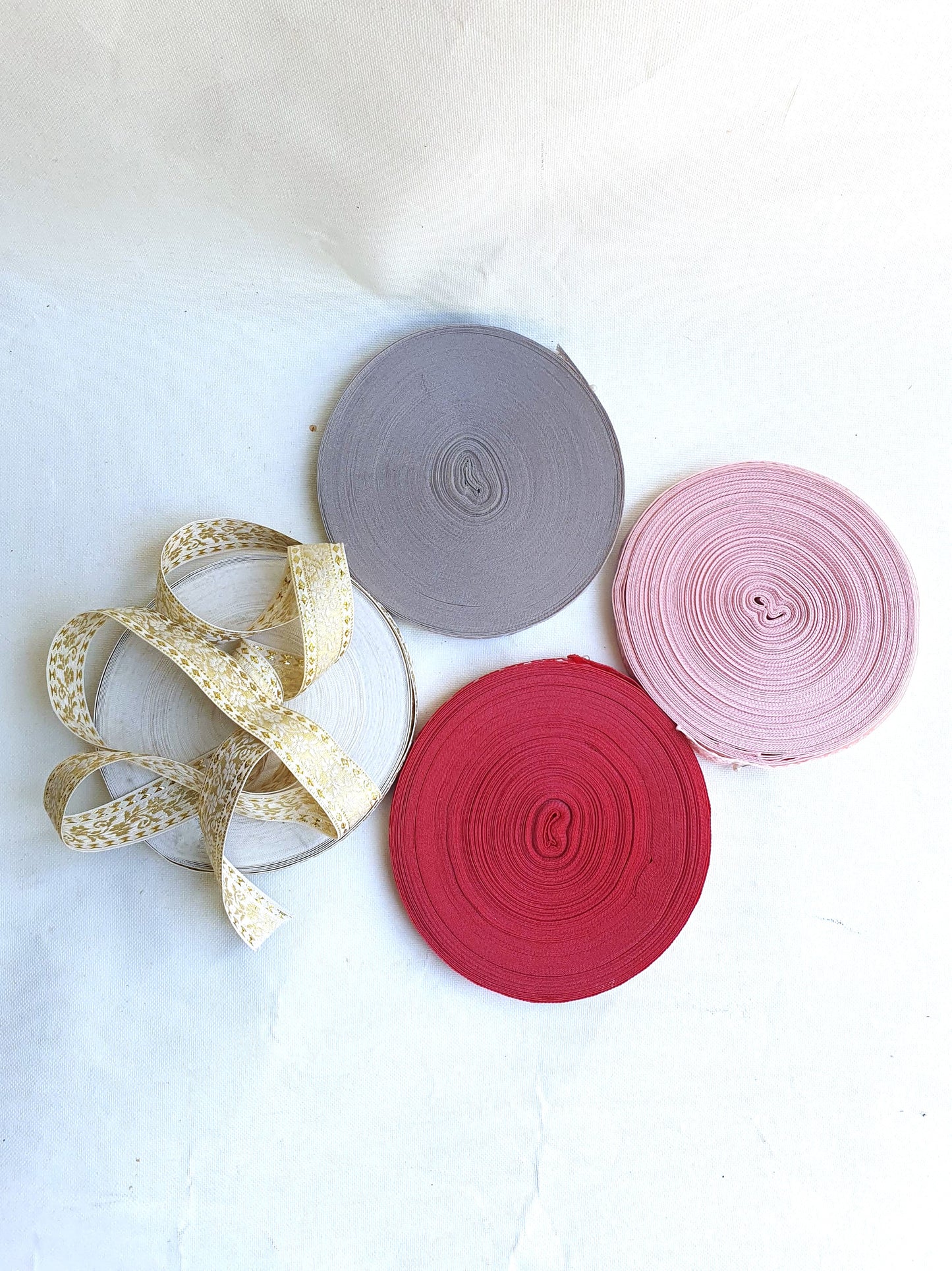 Four rolls of embroidered ribbons