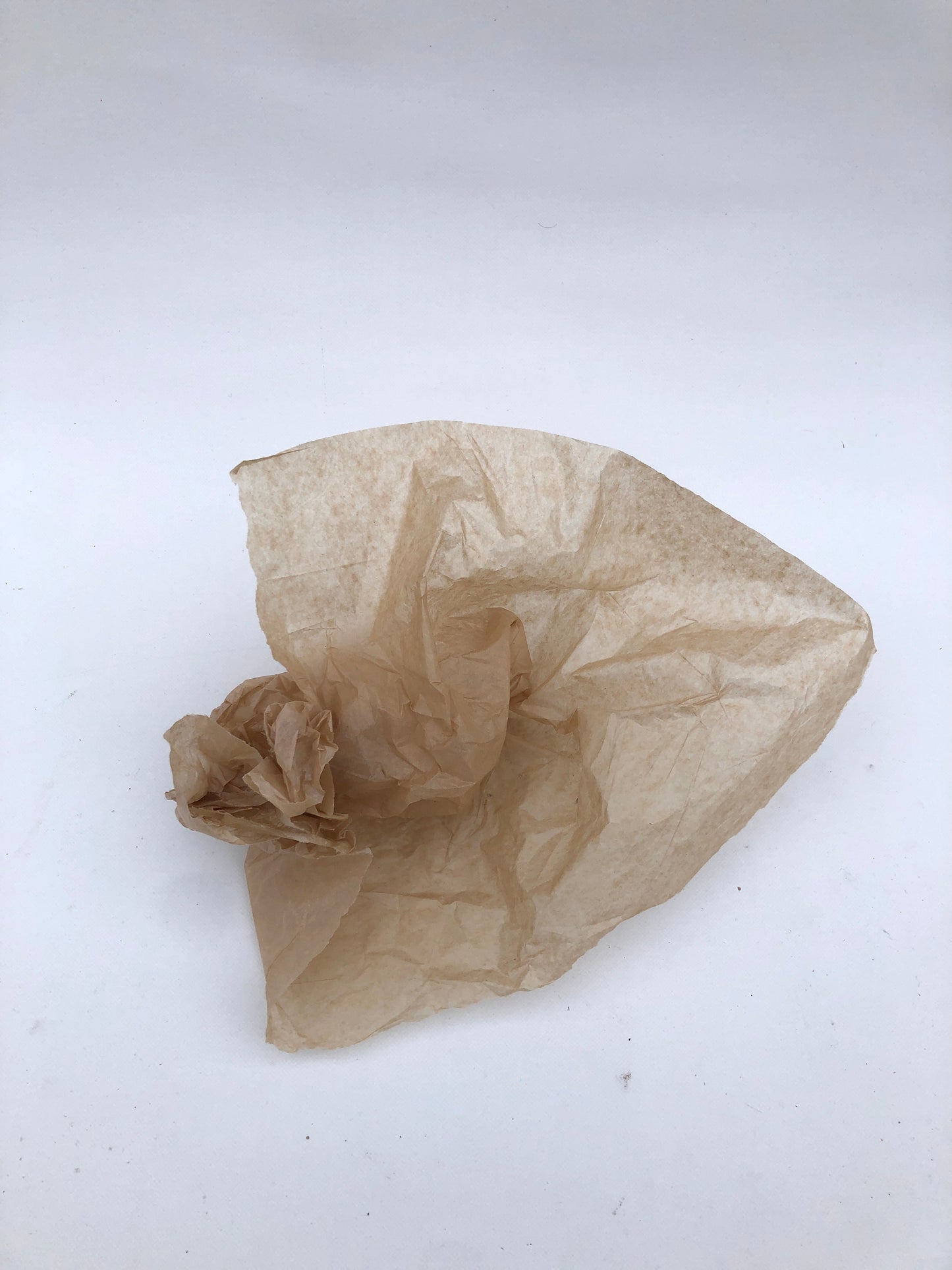 A crumpled piece of brown tissue paper