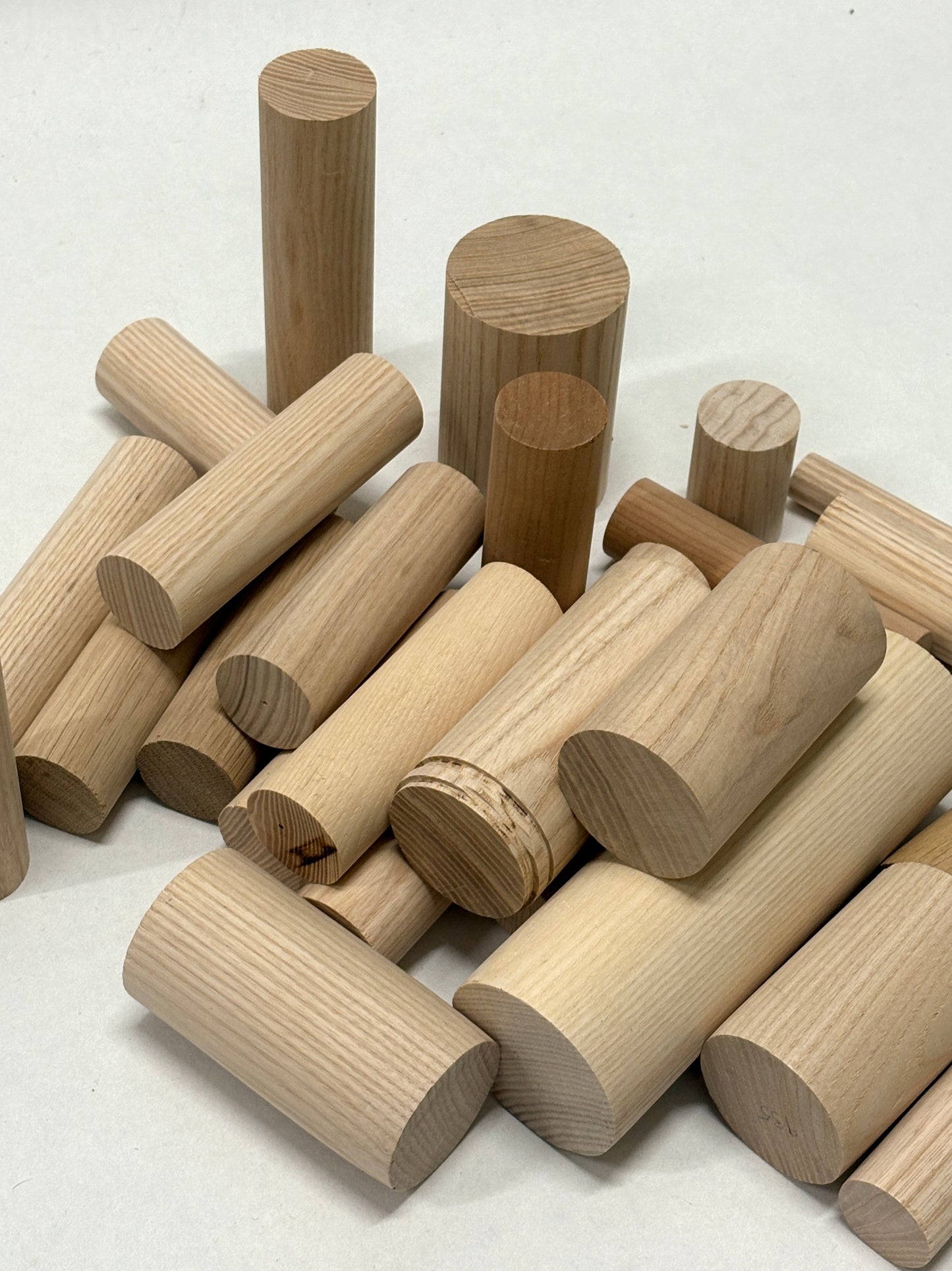 Collection of wooden cylindrical blocks on a white background