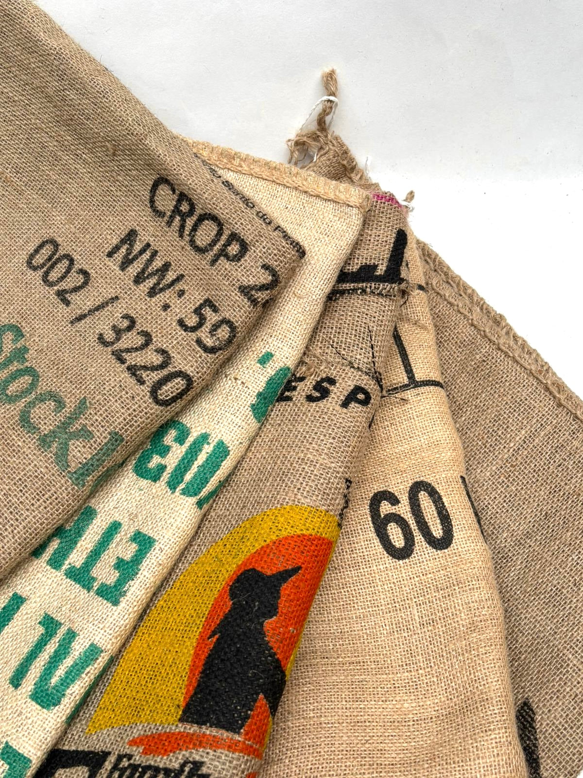 Close-up of burlap sacks with text and graphics on a white background