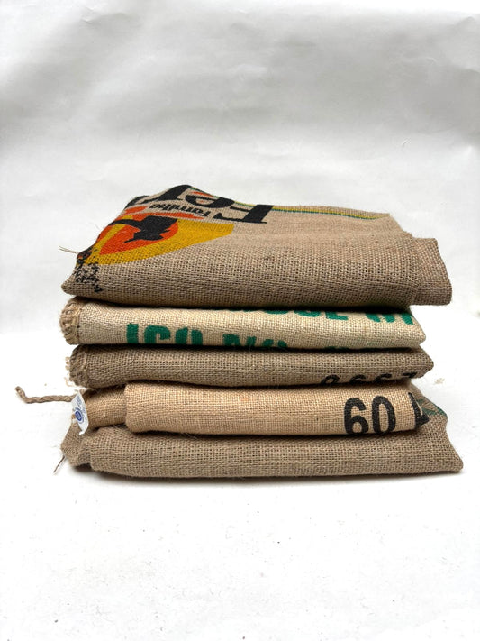 Stack of coffee sacks with visible text on a white background