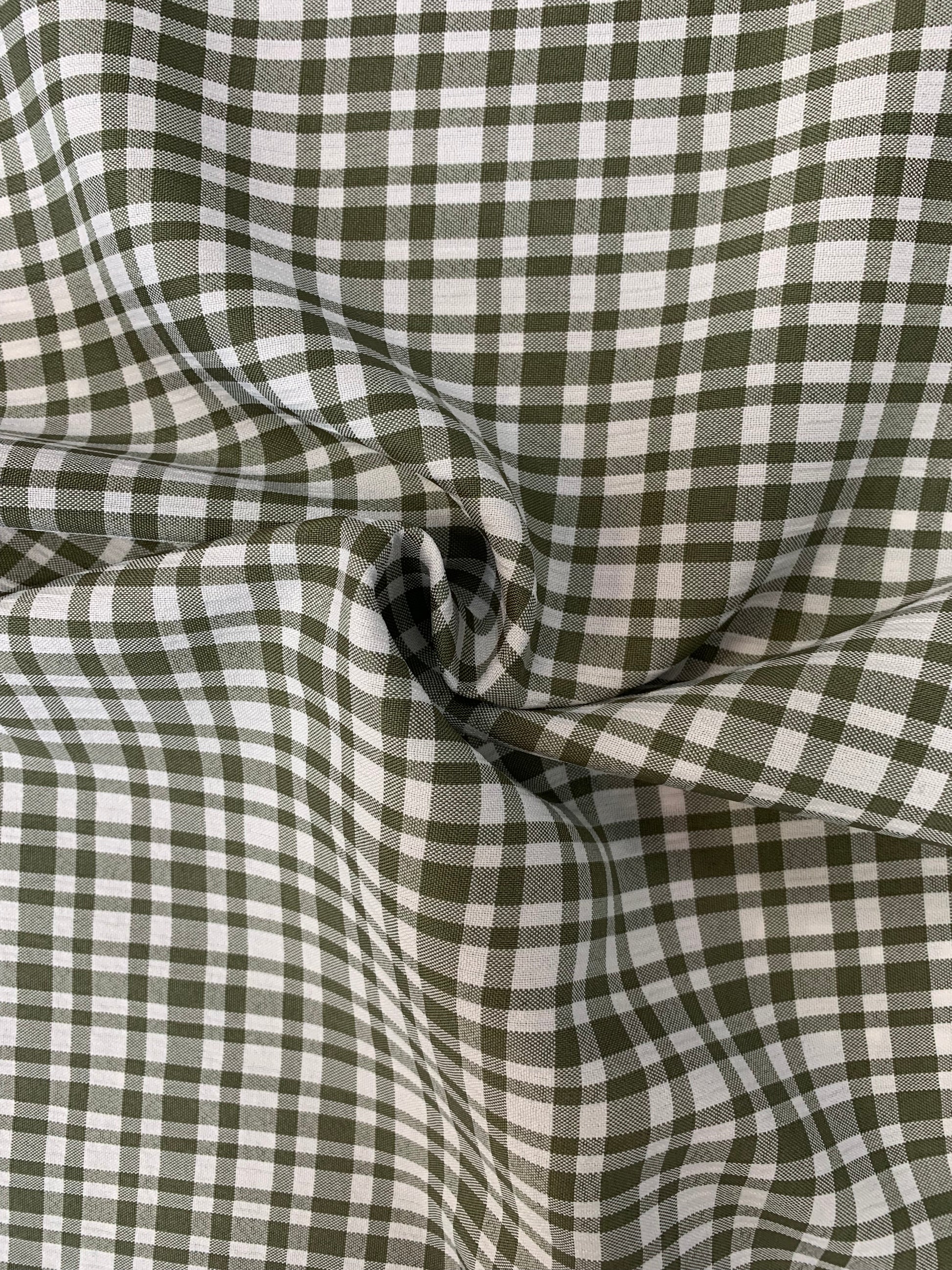Surface detail of khaki and white apple check deadstock fabric.