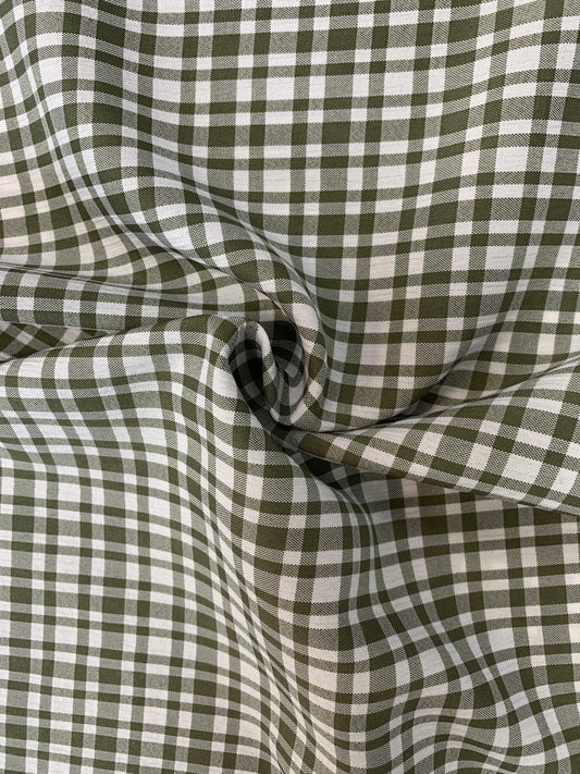 Surface detail of khaki and white apple check deadstock fabric.
