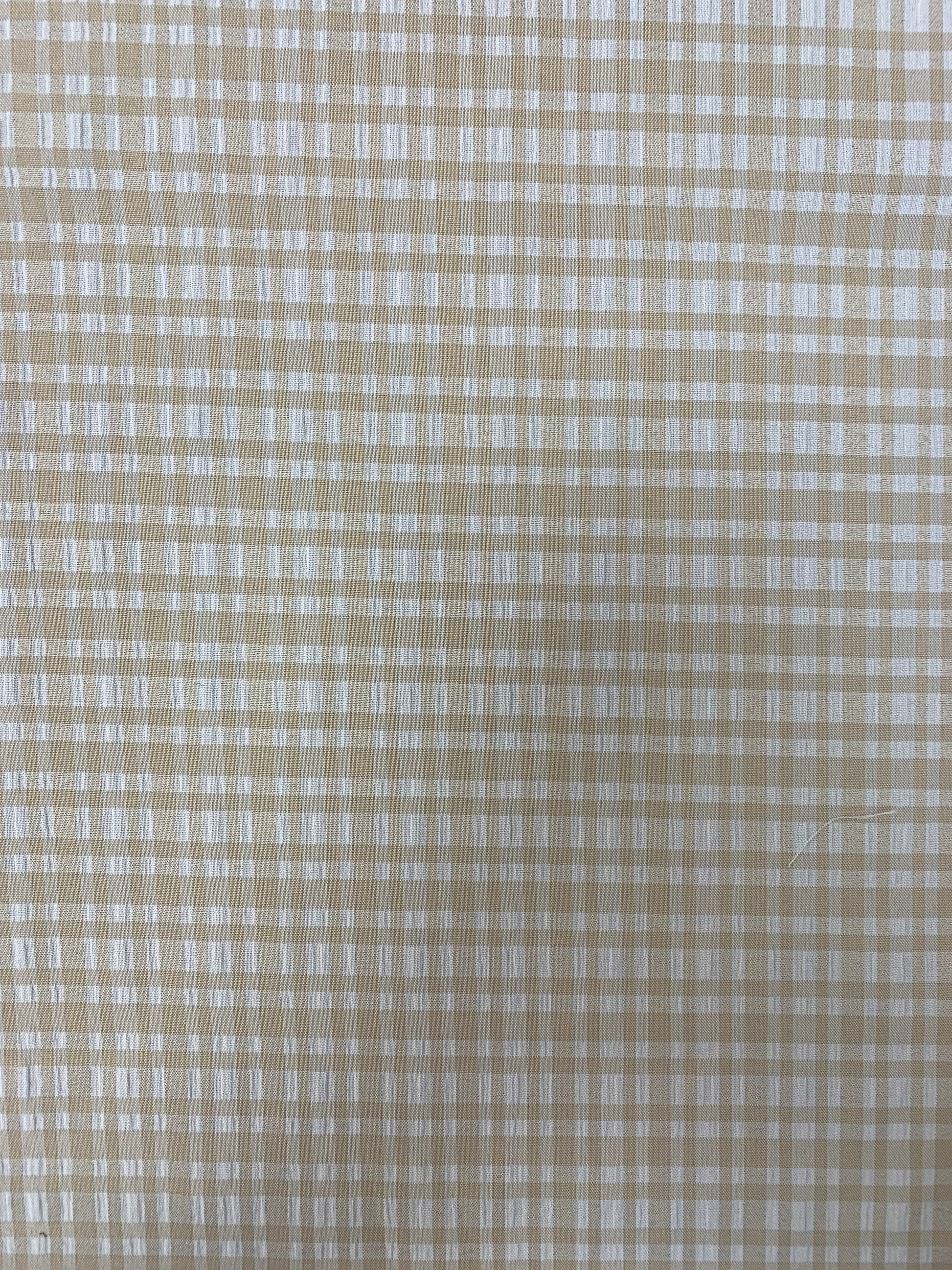 Macro view of the stone and white apple check weave.