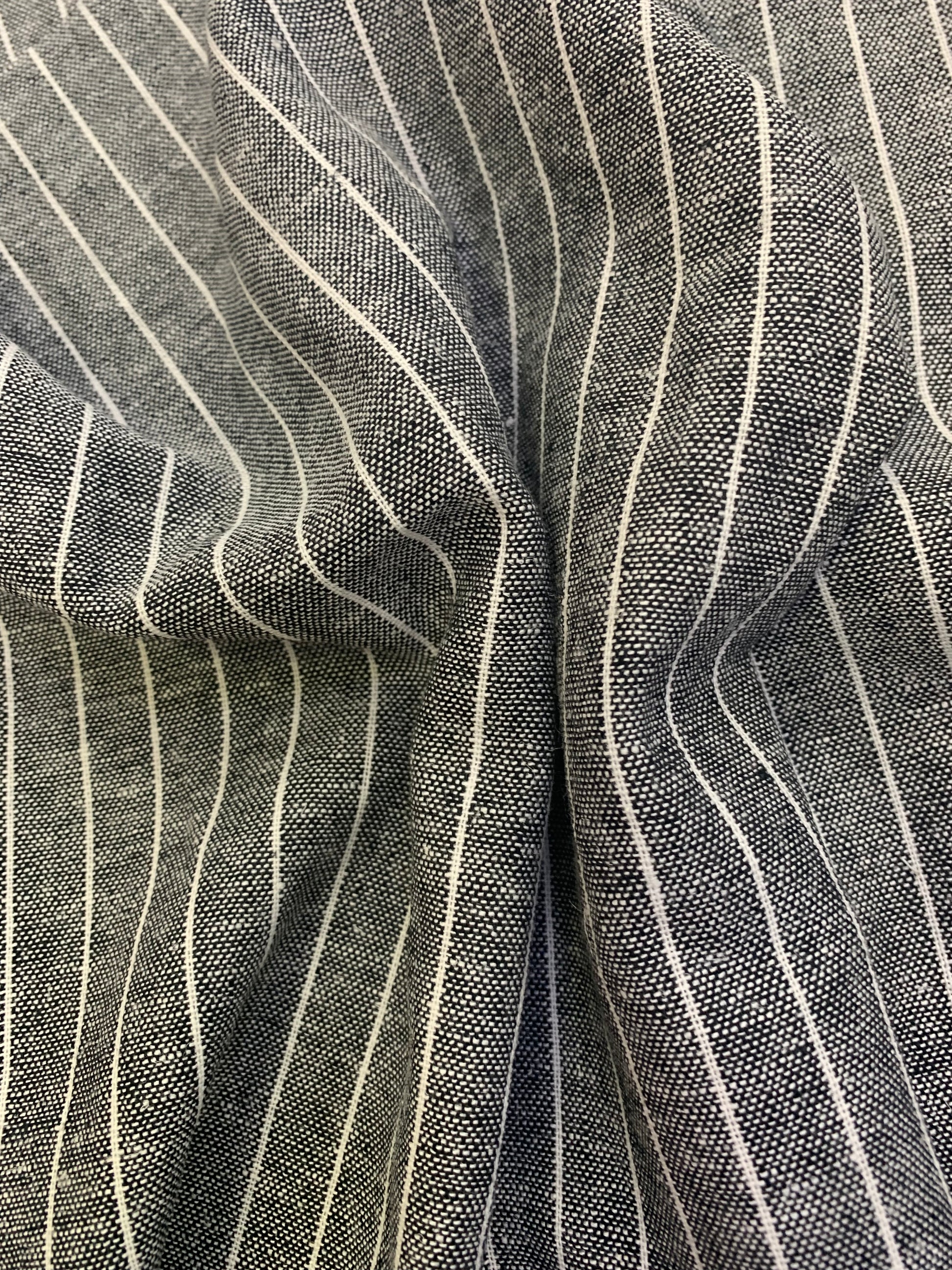 Folded detail of black-white stripe linen blend deadstock fabric.