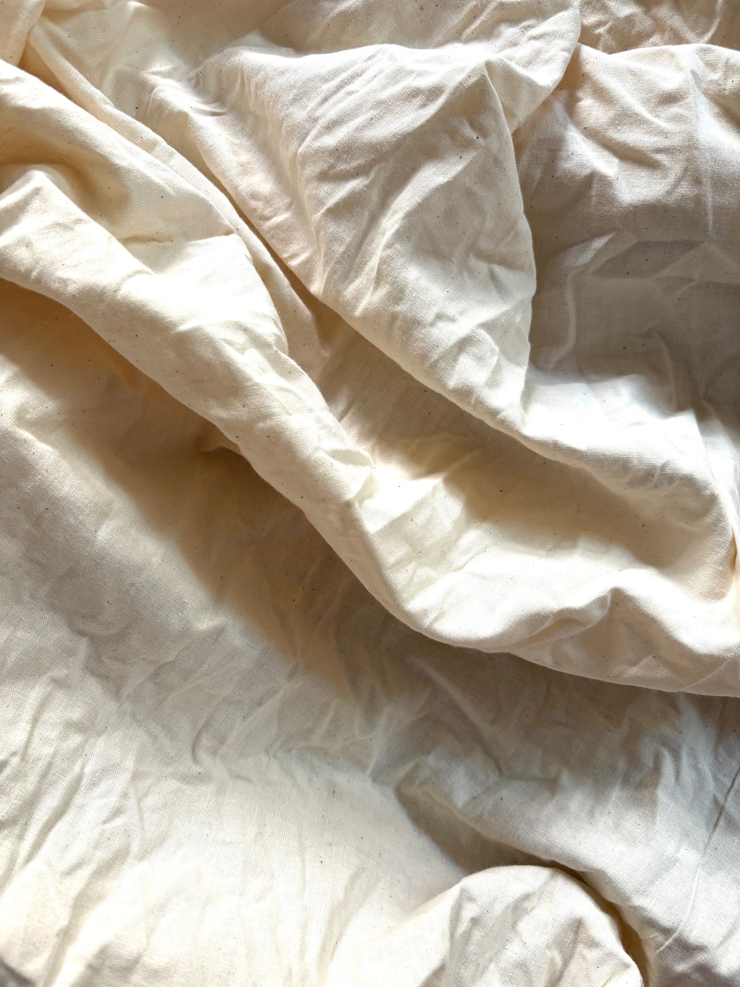 100% cotton calico fabric shown in a softly collapsed arrangement.