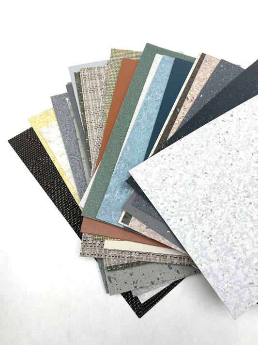 Textured floor samples are fanned out on a white background