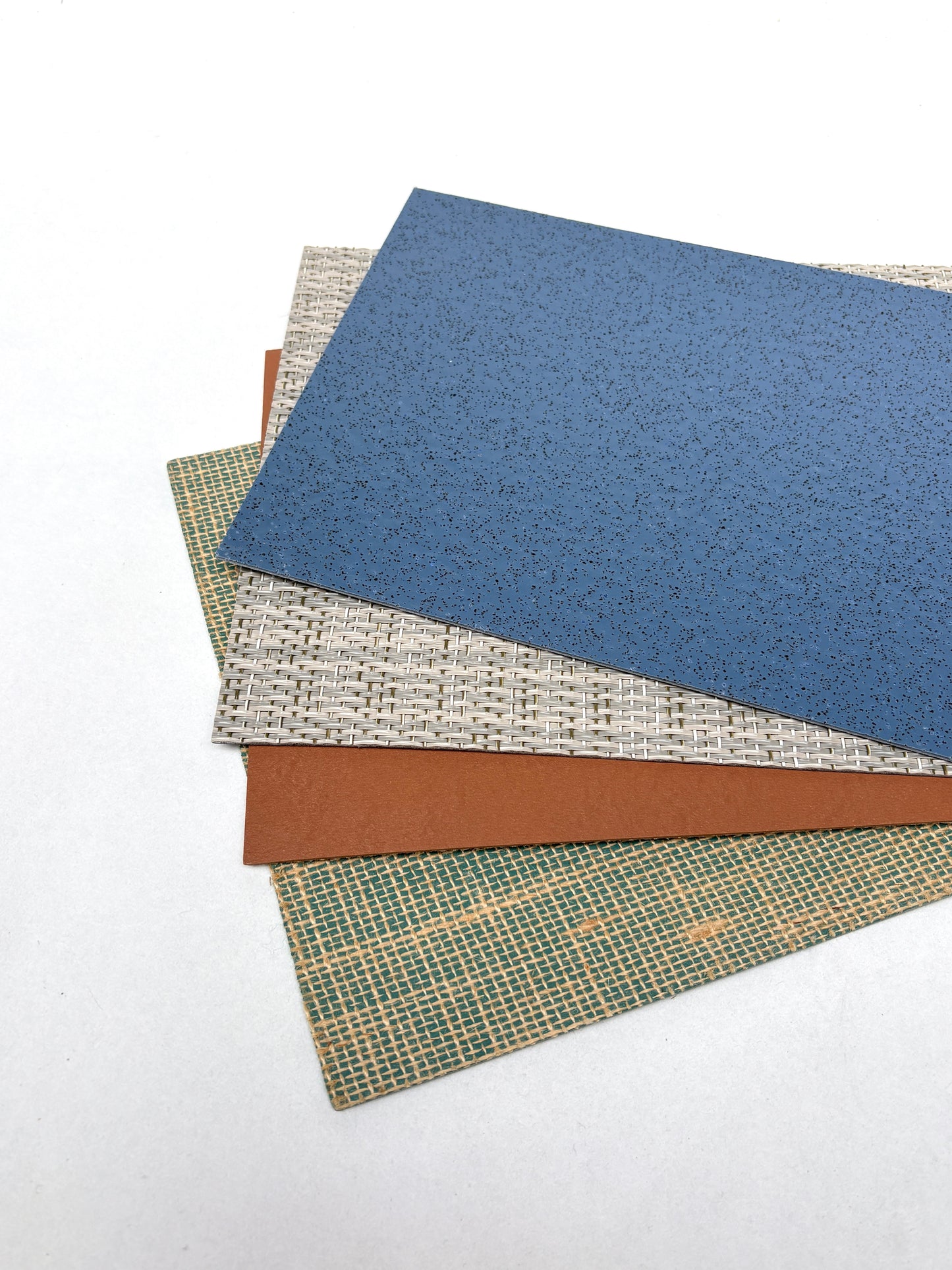Bendable textured sheets are spread across a white background