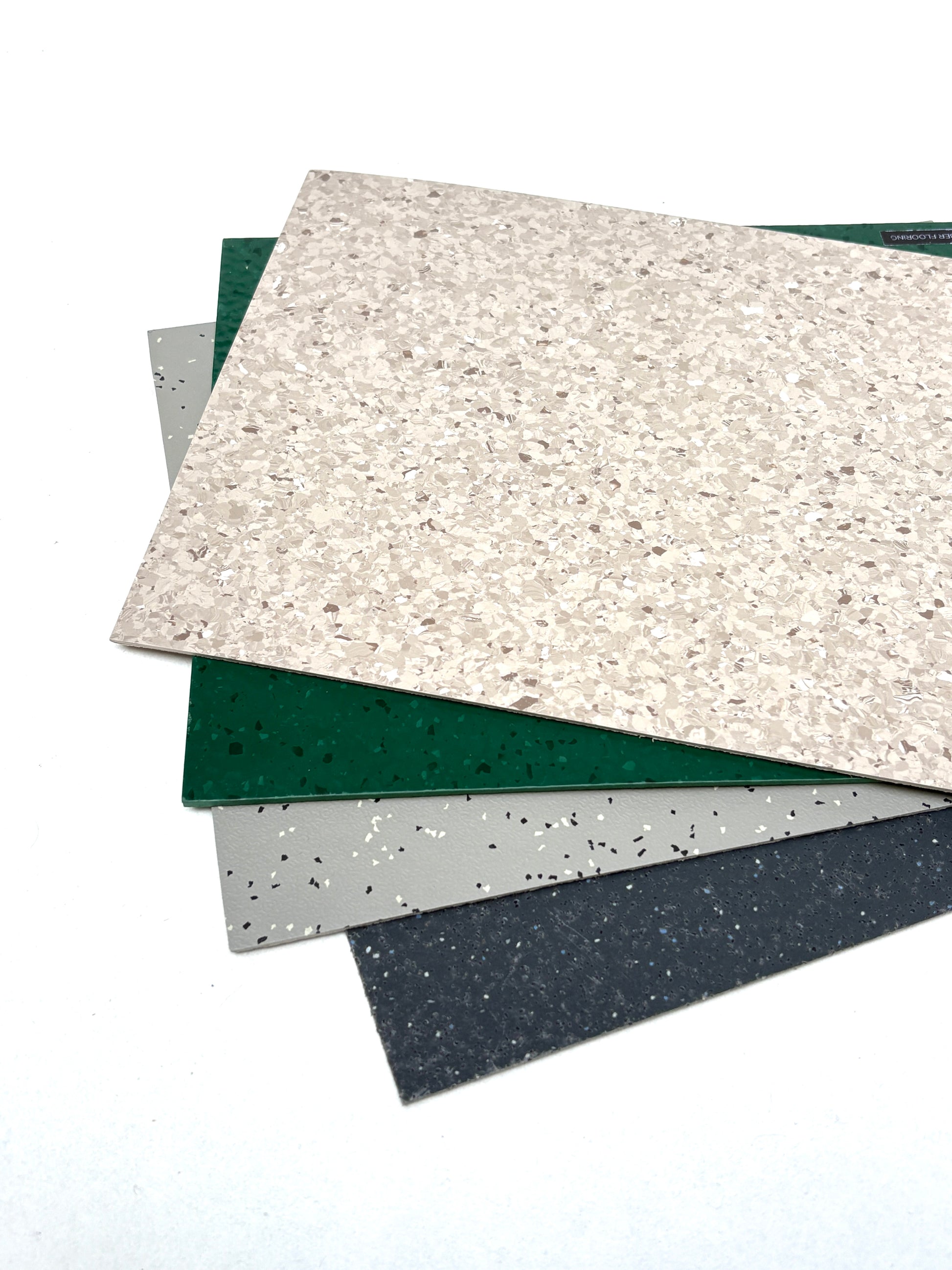 Assorted patterned floor samples overlap on a white surface
