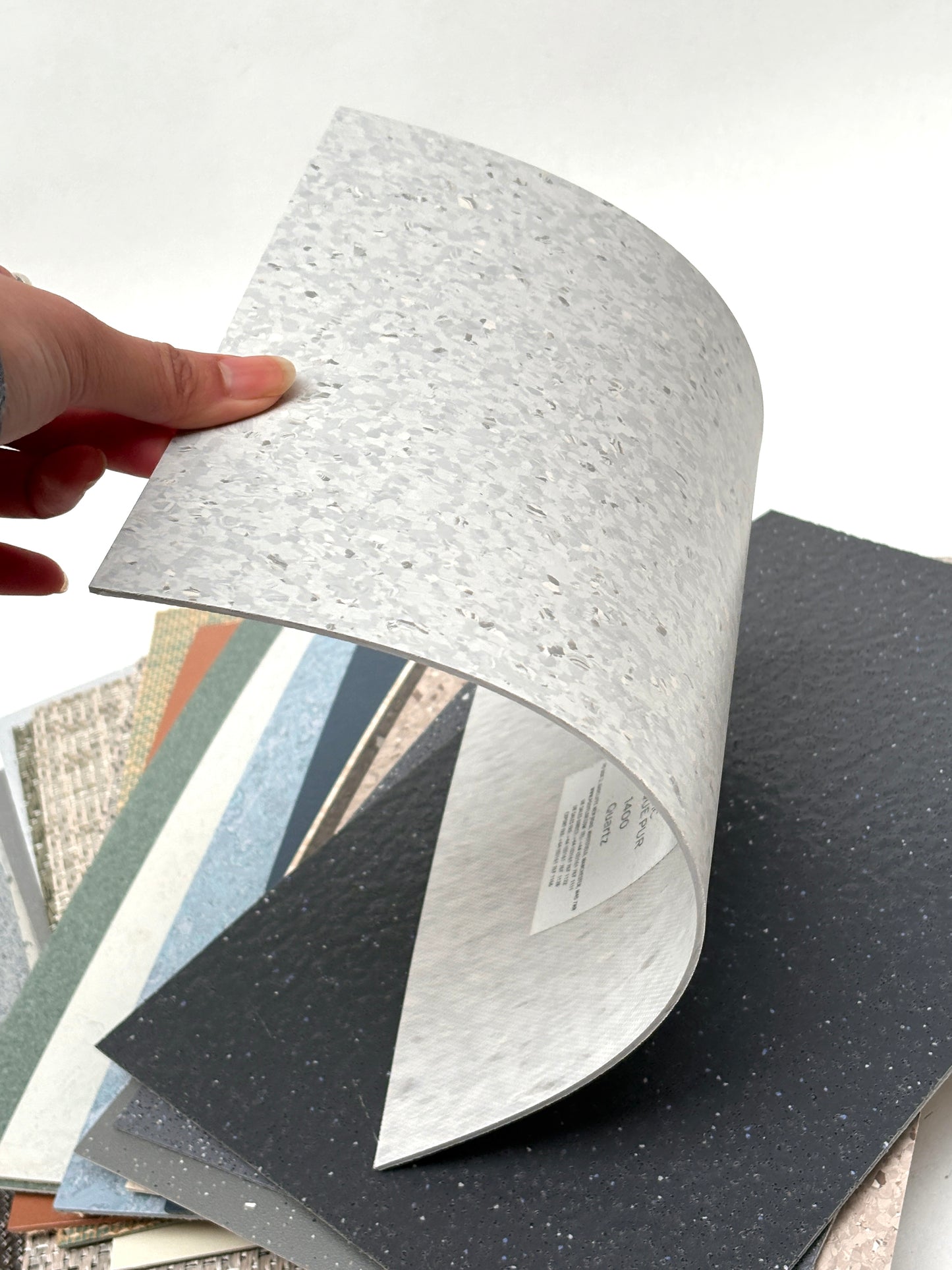 Thin textured material samples are displayed in a fan shape