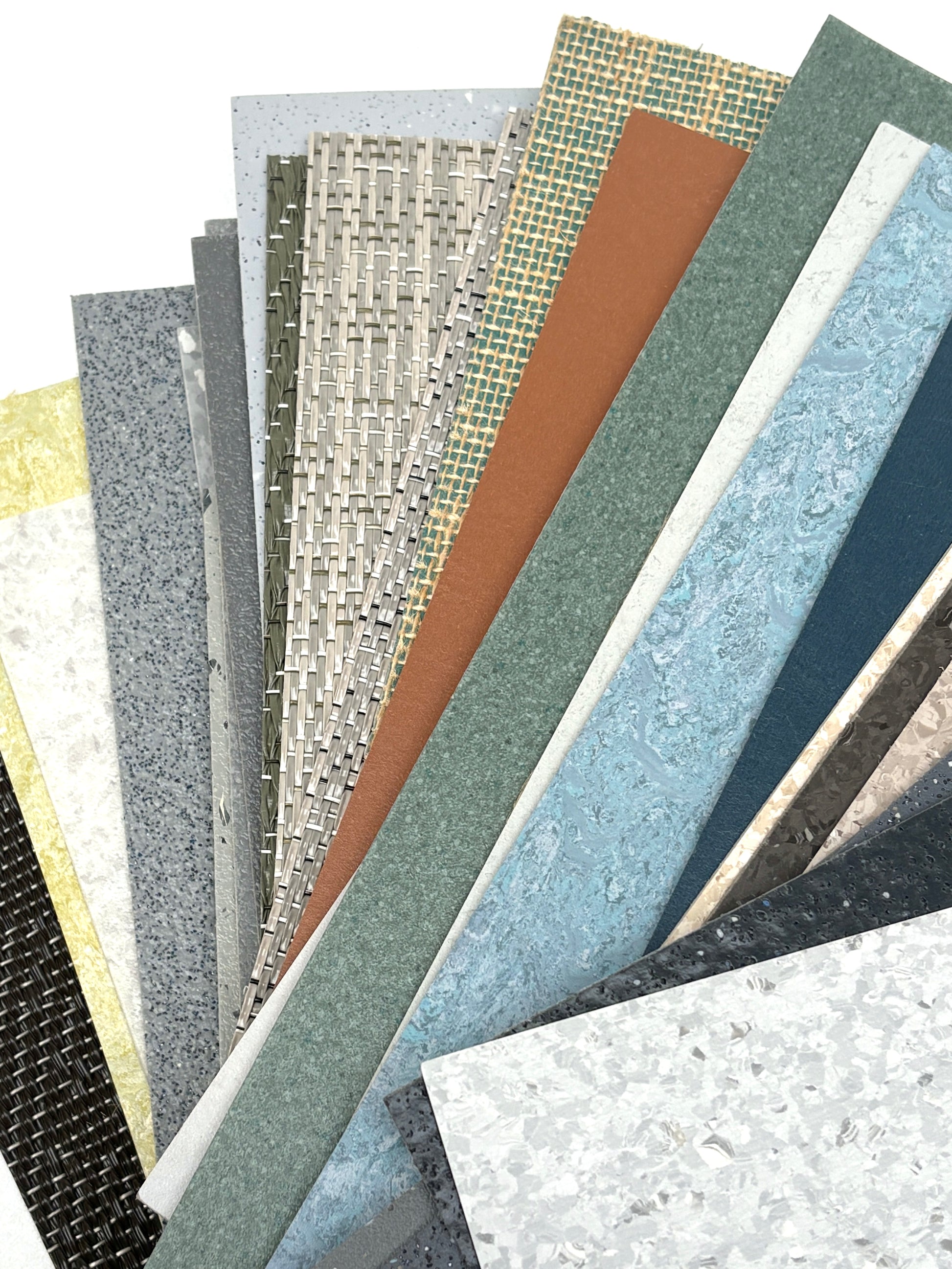 Mixed floor sample pieces lie layered on a white background