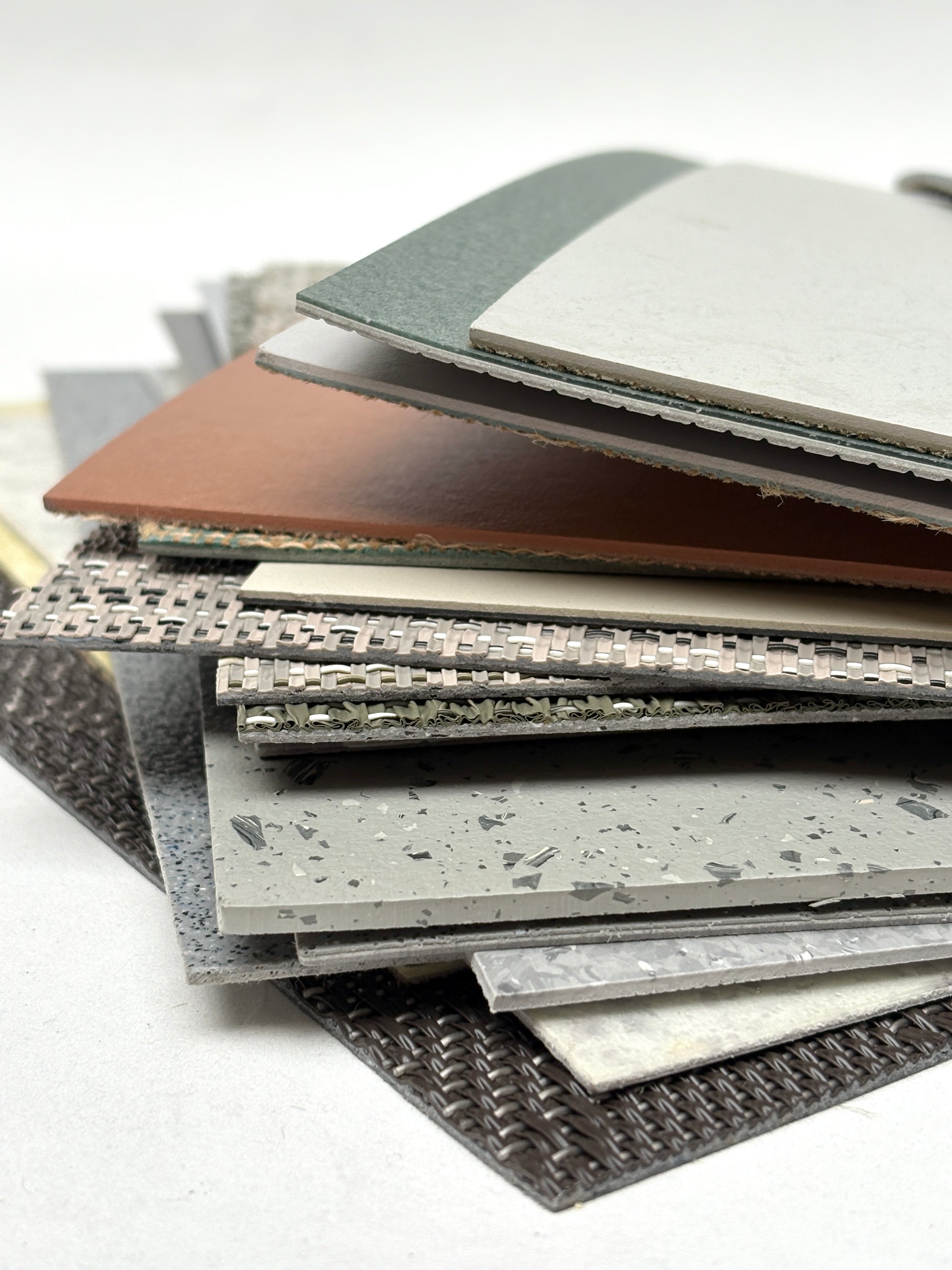 Assorted patterned floor samples overlap on a white surface