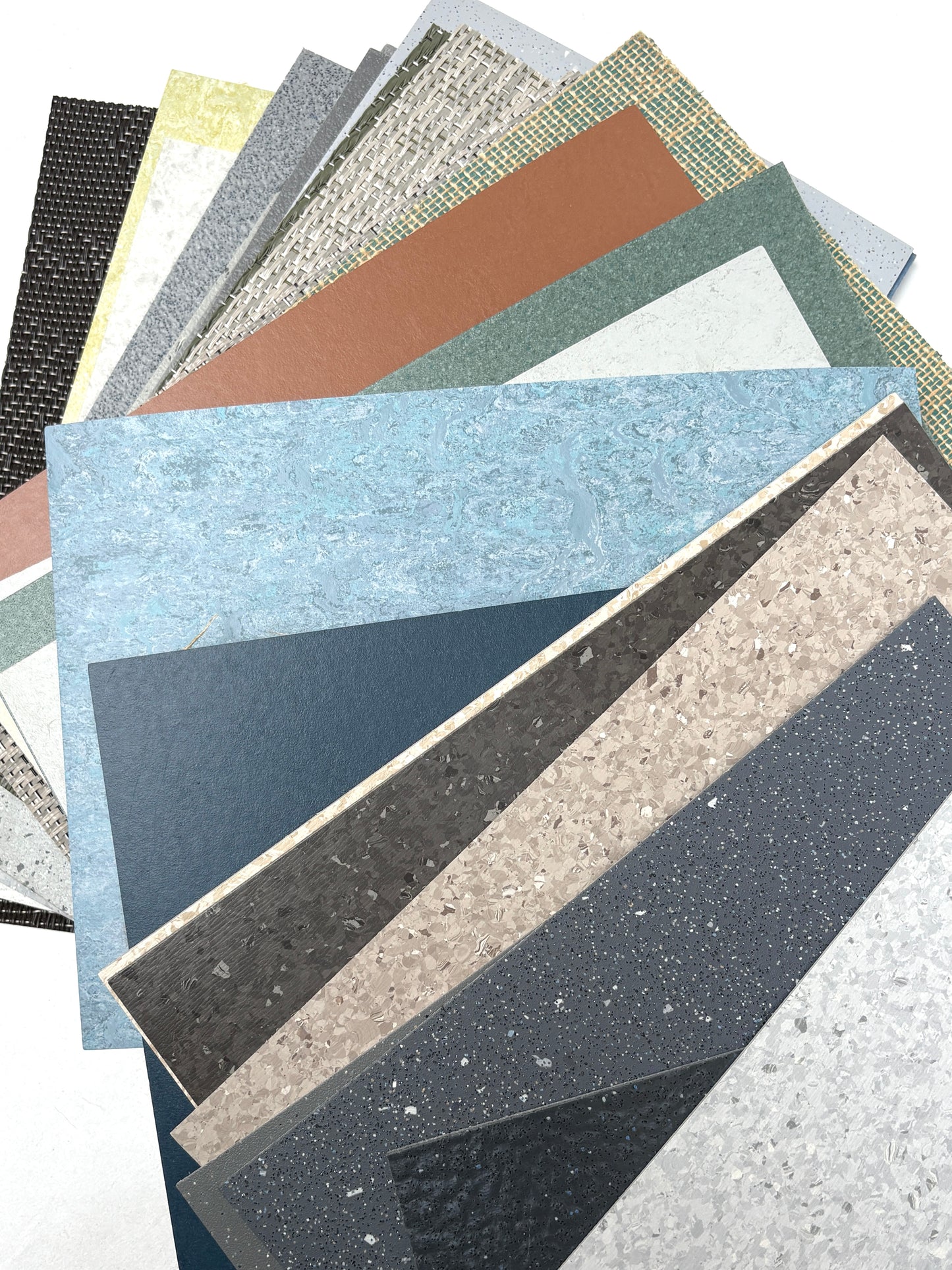 Textured floor samples are fanned out on a white background