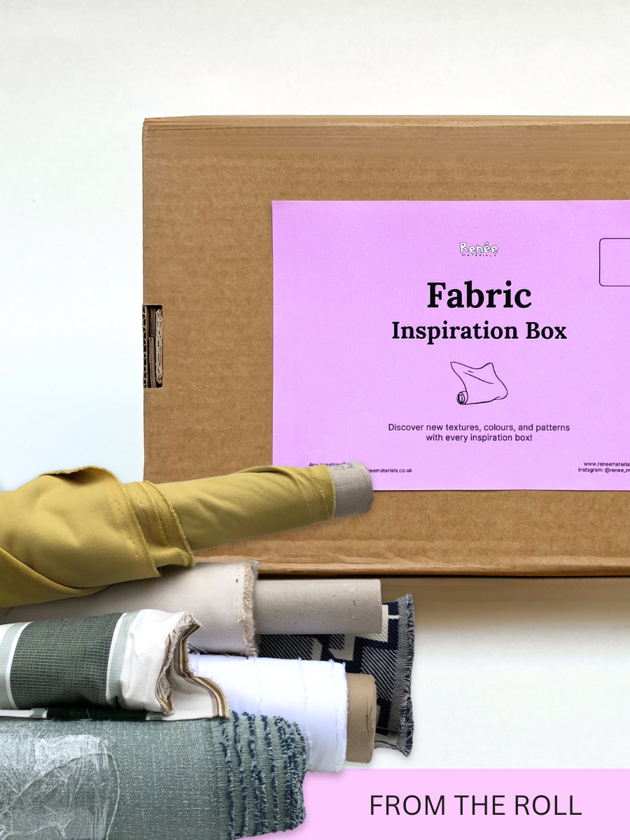 A fabric inspiration box displayed with a selection of rolled fabric samples.