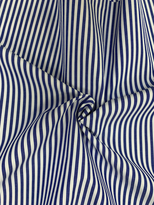 Close-up of denim blue-white stripe fabric gathered in gentle folds.