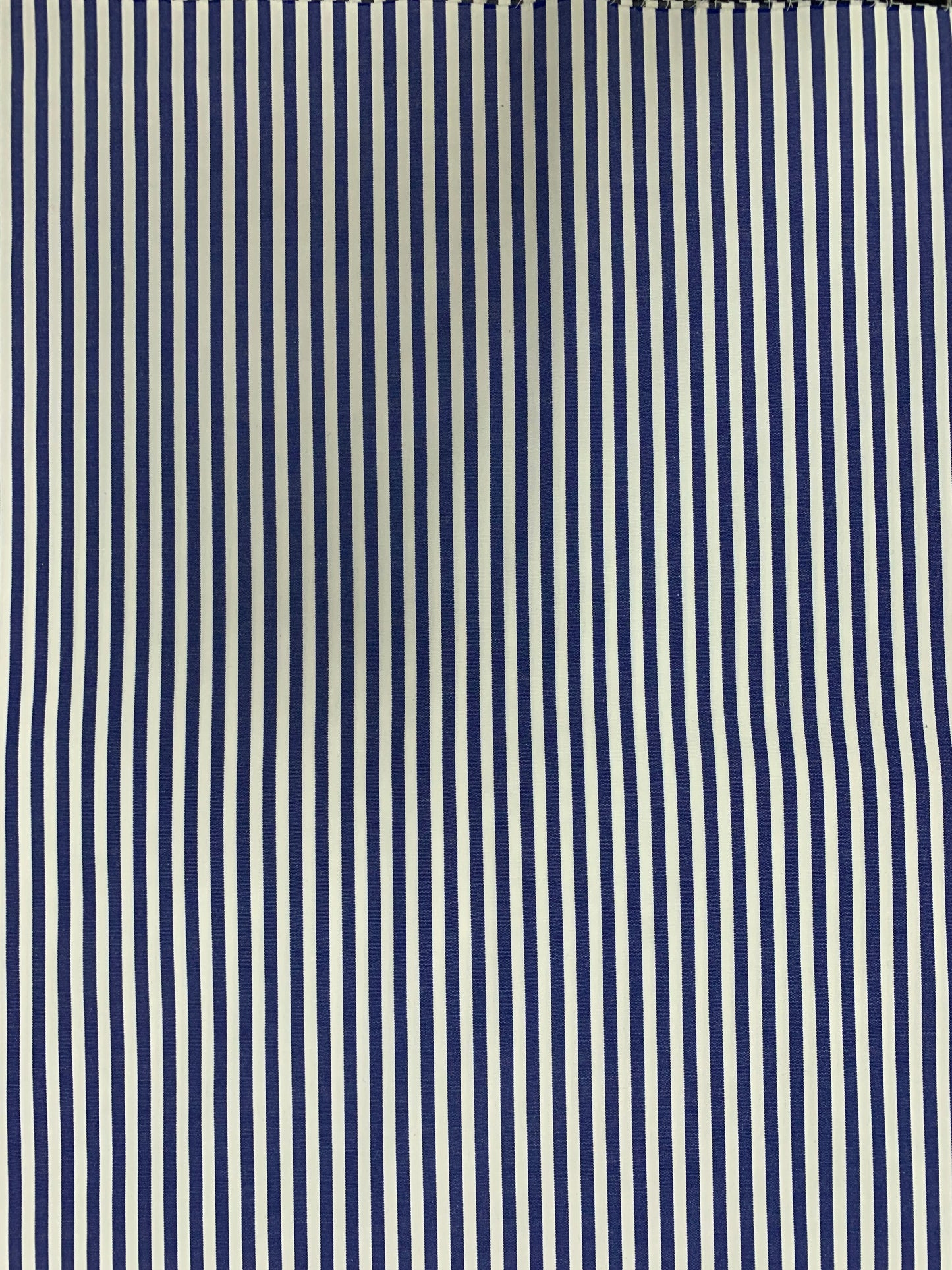 Denim blue-white stripe fabric laid flat in close detail.