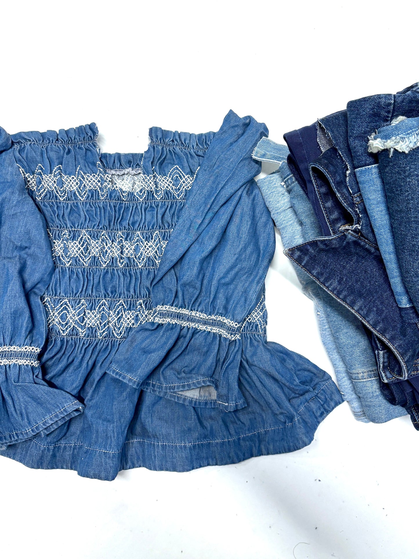 Blue denim dress with smocked details and a matching denim jacket on a white background for upcycling and reuse projects