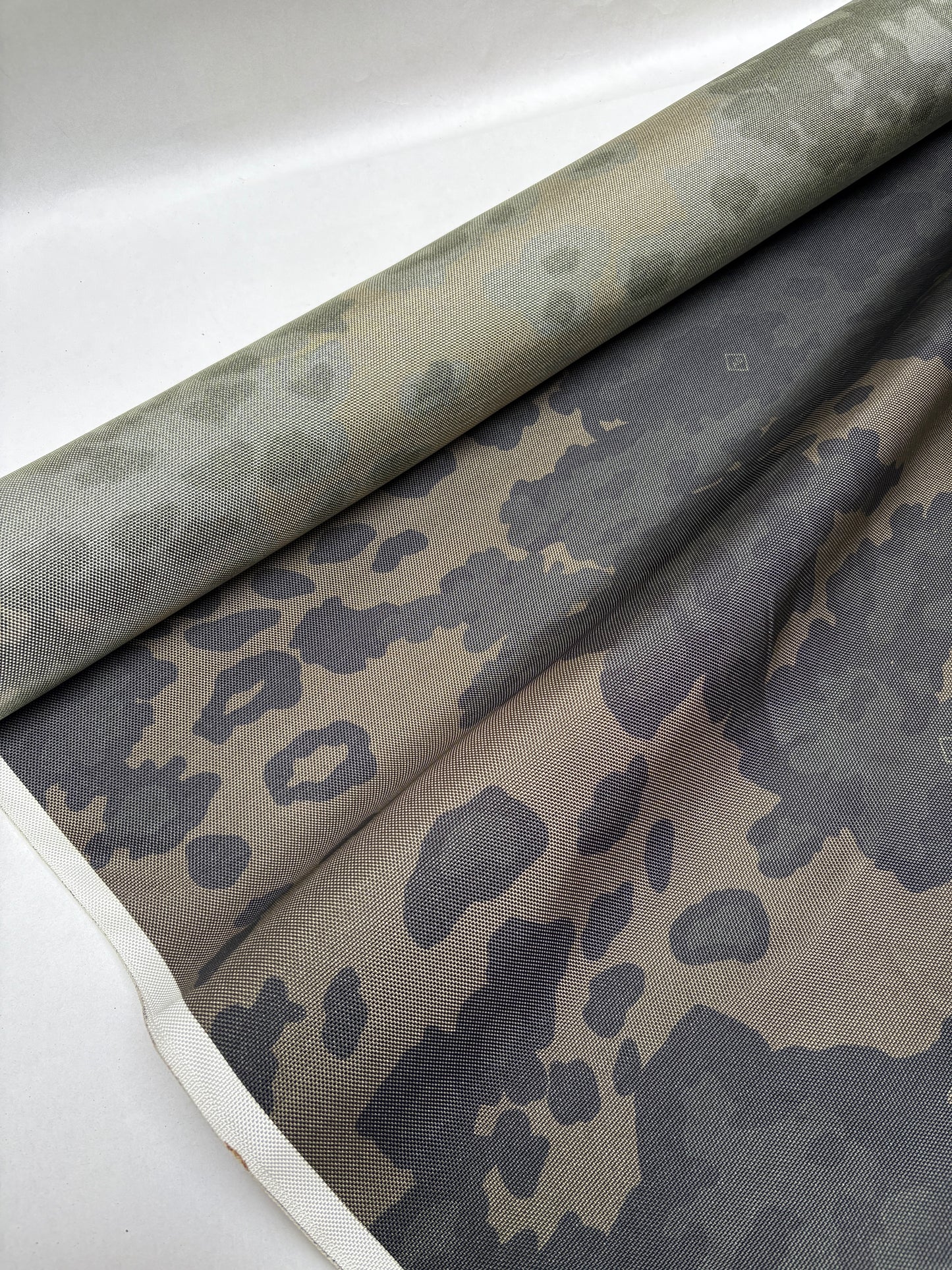 Dark green and khaki fabric draped in loose folded shapes.