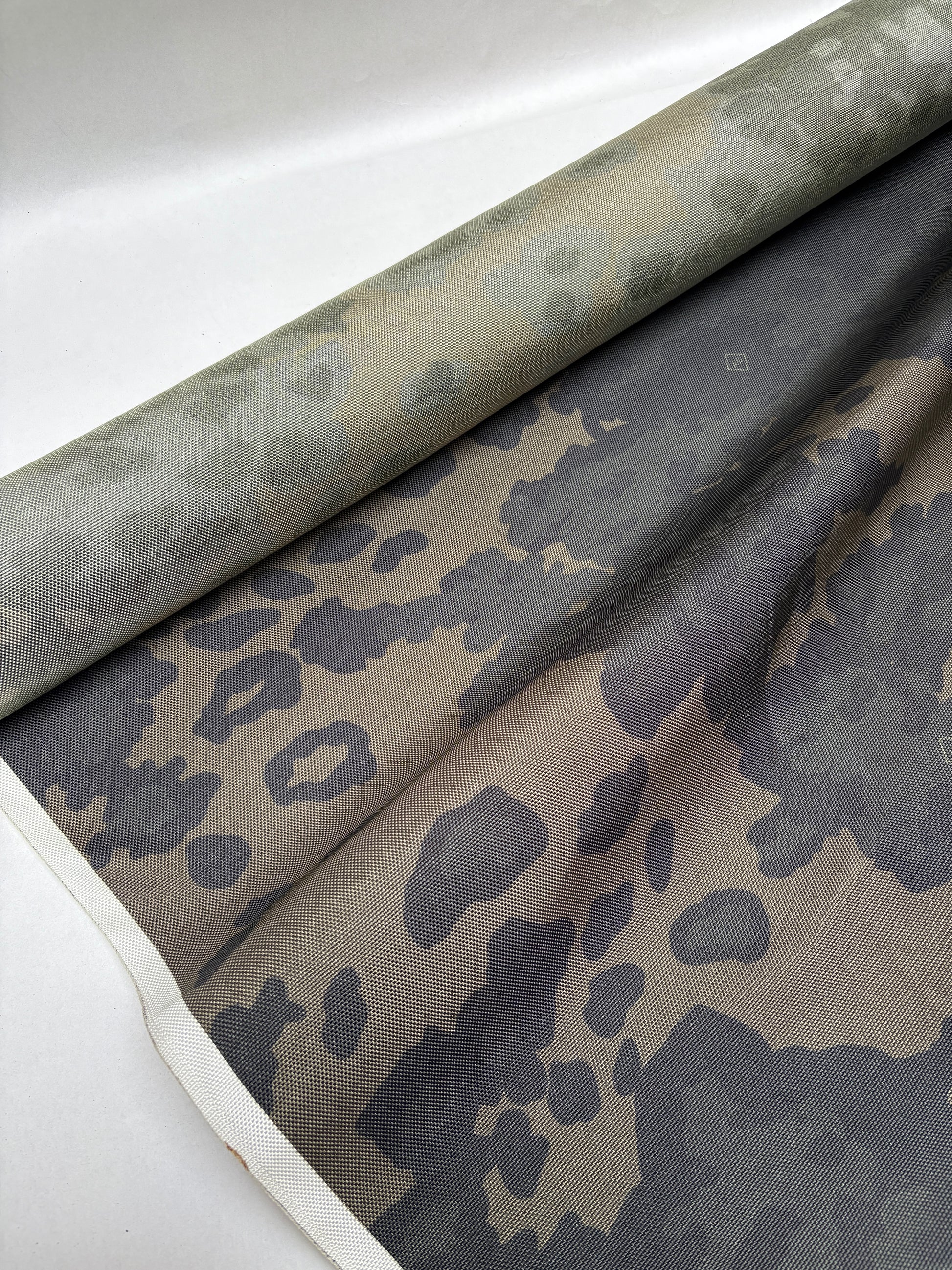 Dark green and khaki fabric draped in loose folded shapes.