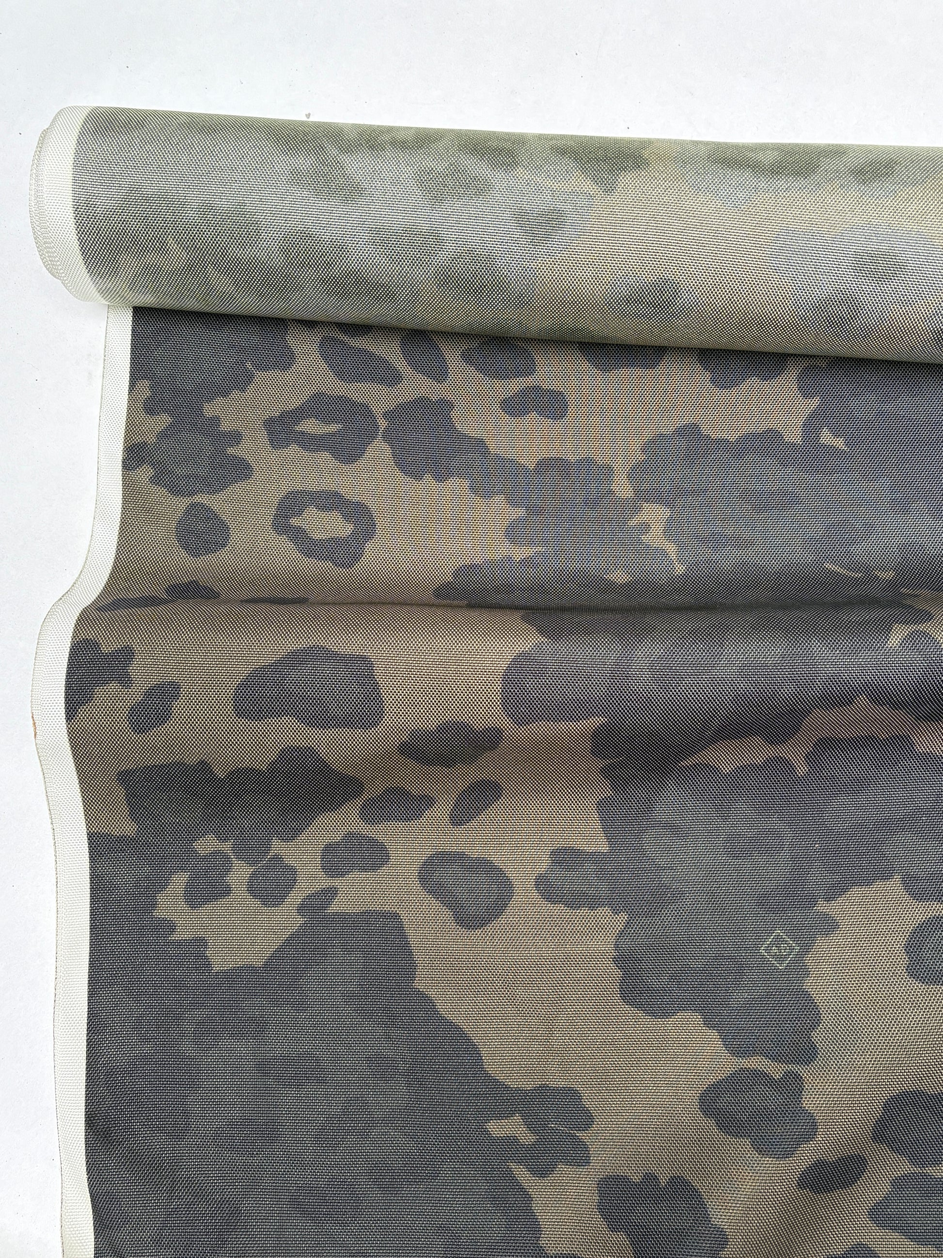 End-of-roll camouflage fabric displayed in soft folds.