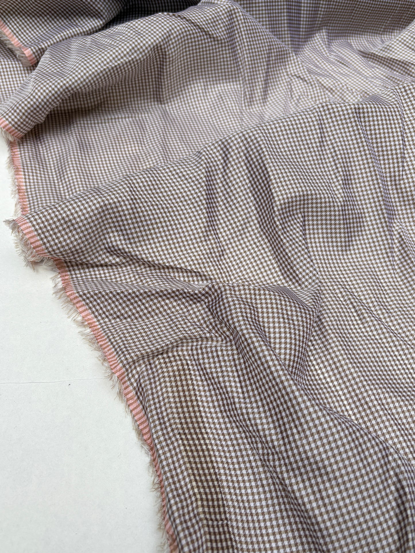 Thin patterned fabric is shown in multiple folded views